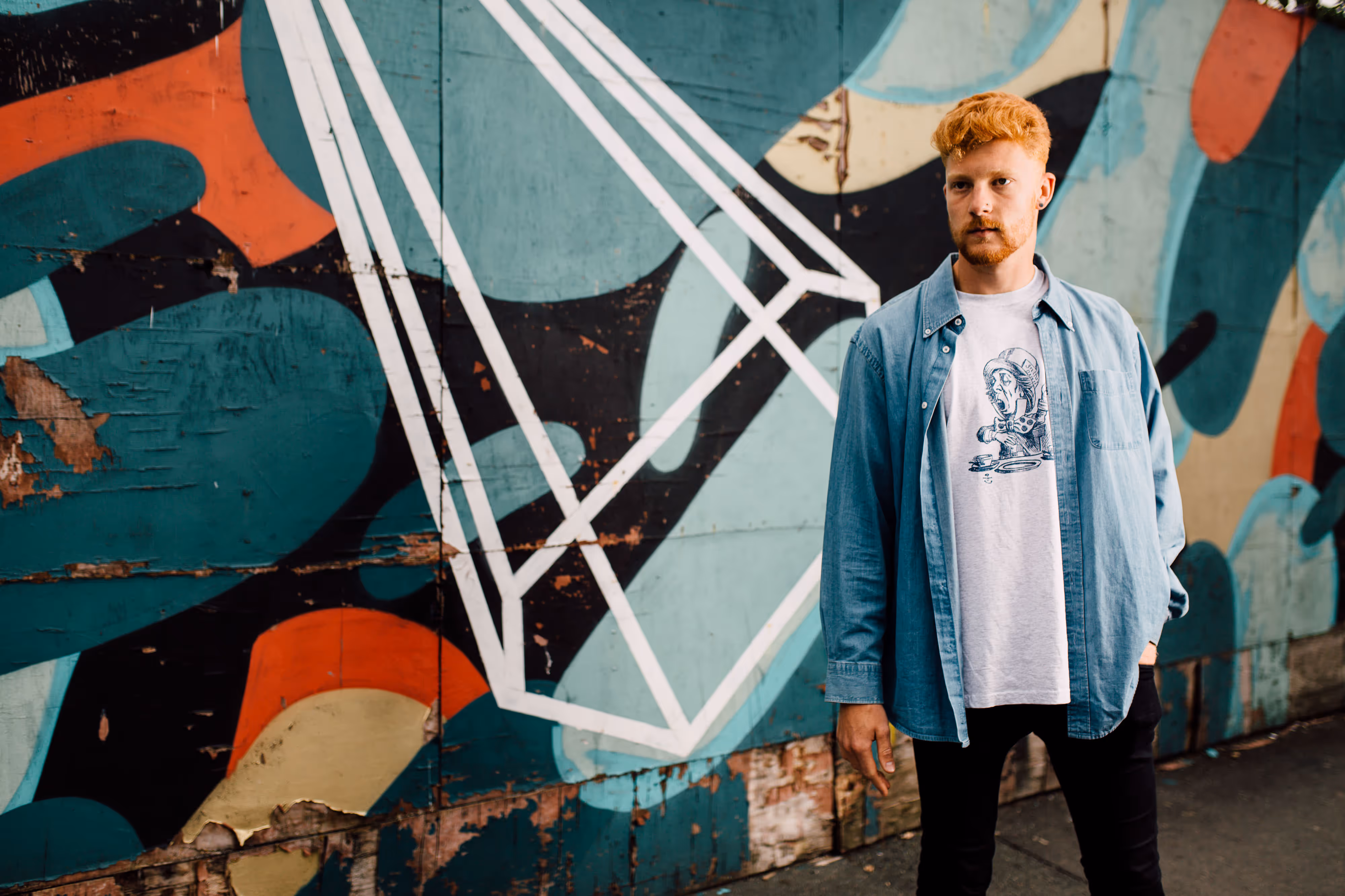 solo artist in front of colourful wall
