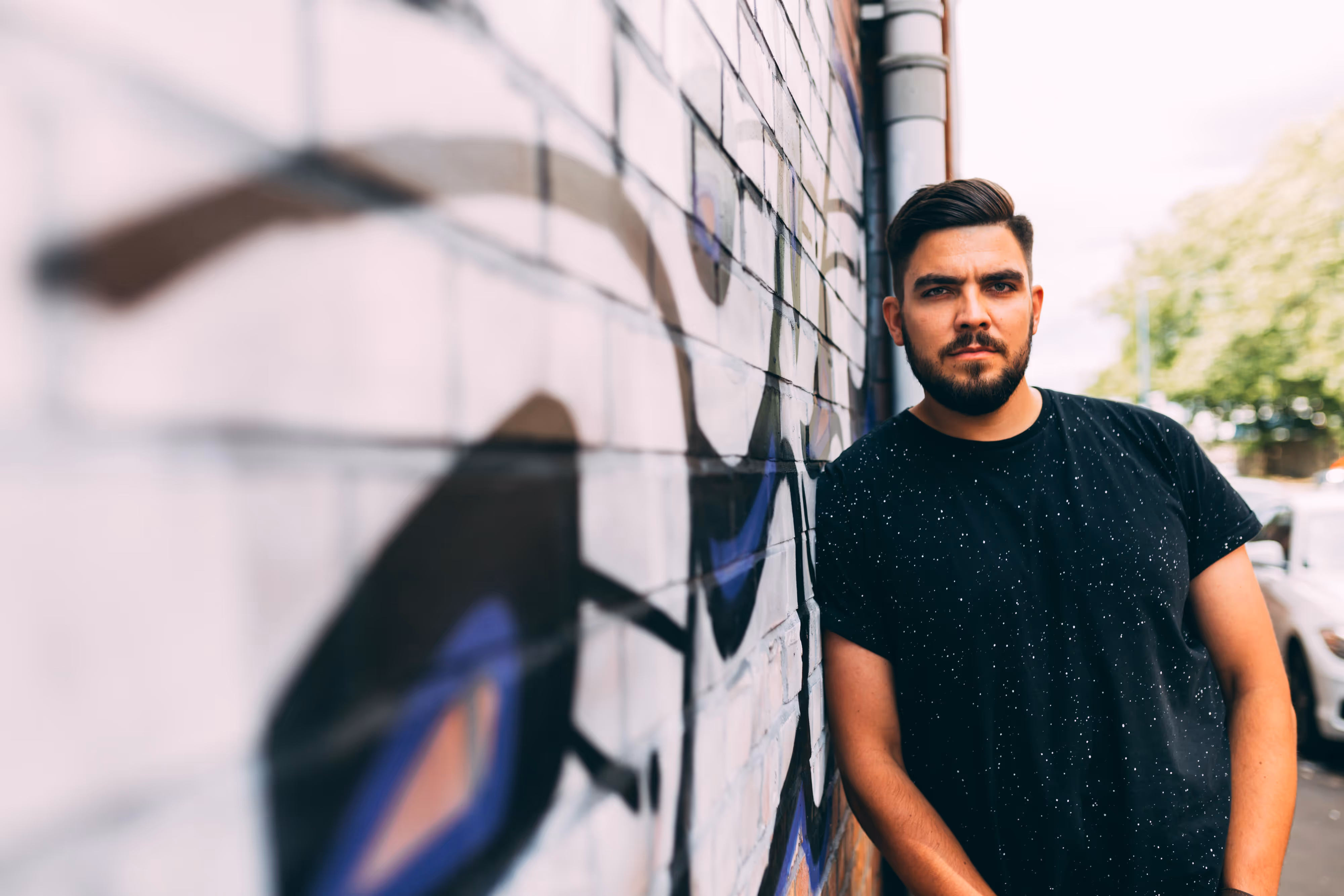 electronic producer leaning against wall in salford
