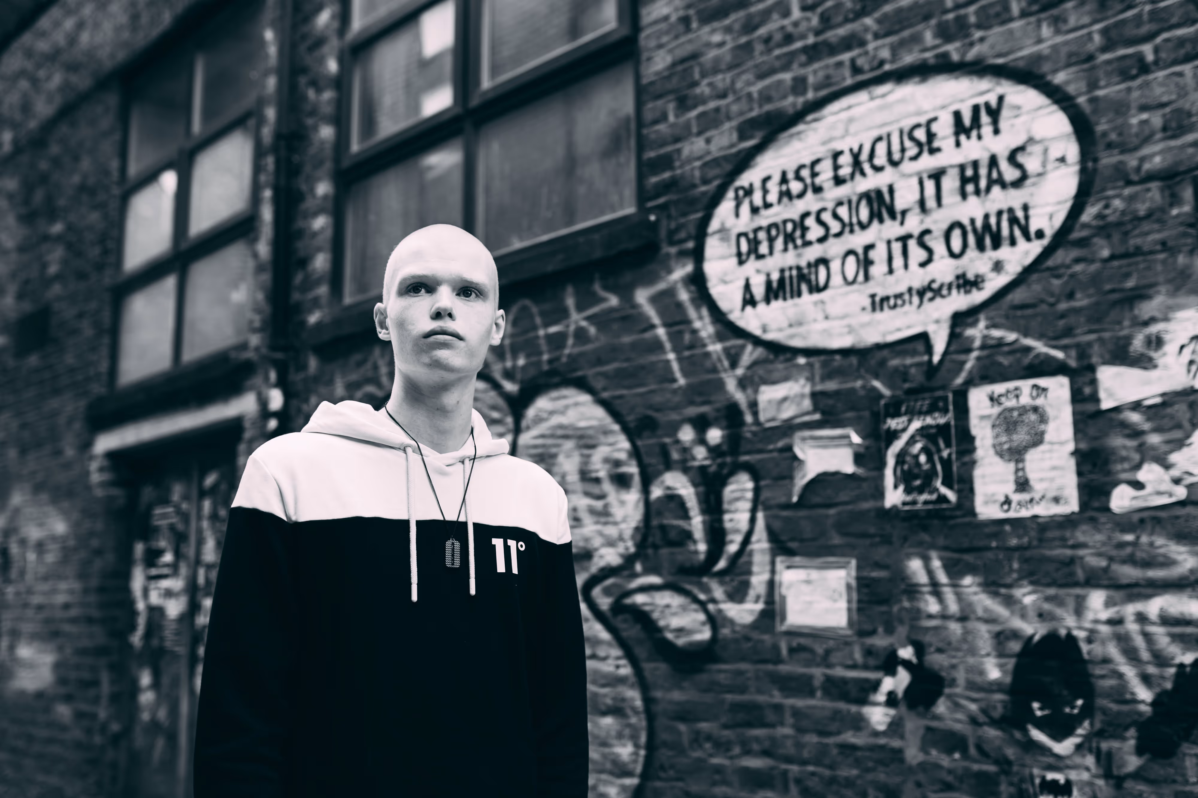 dubstep dj next to mental health graffiti for charity release