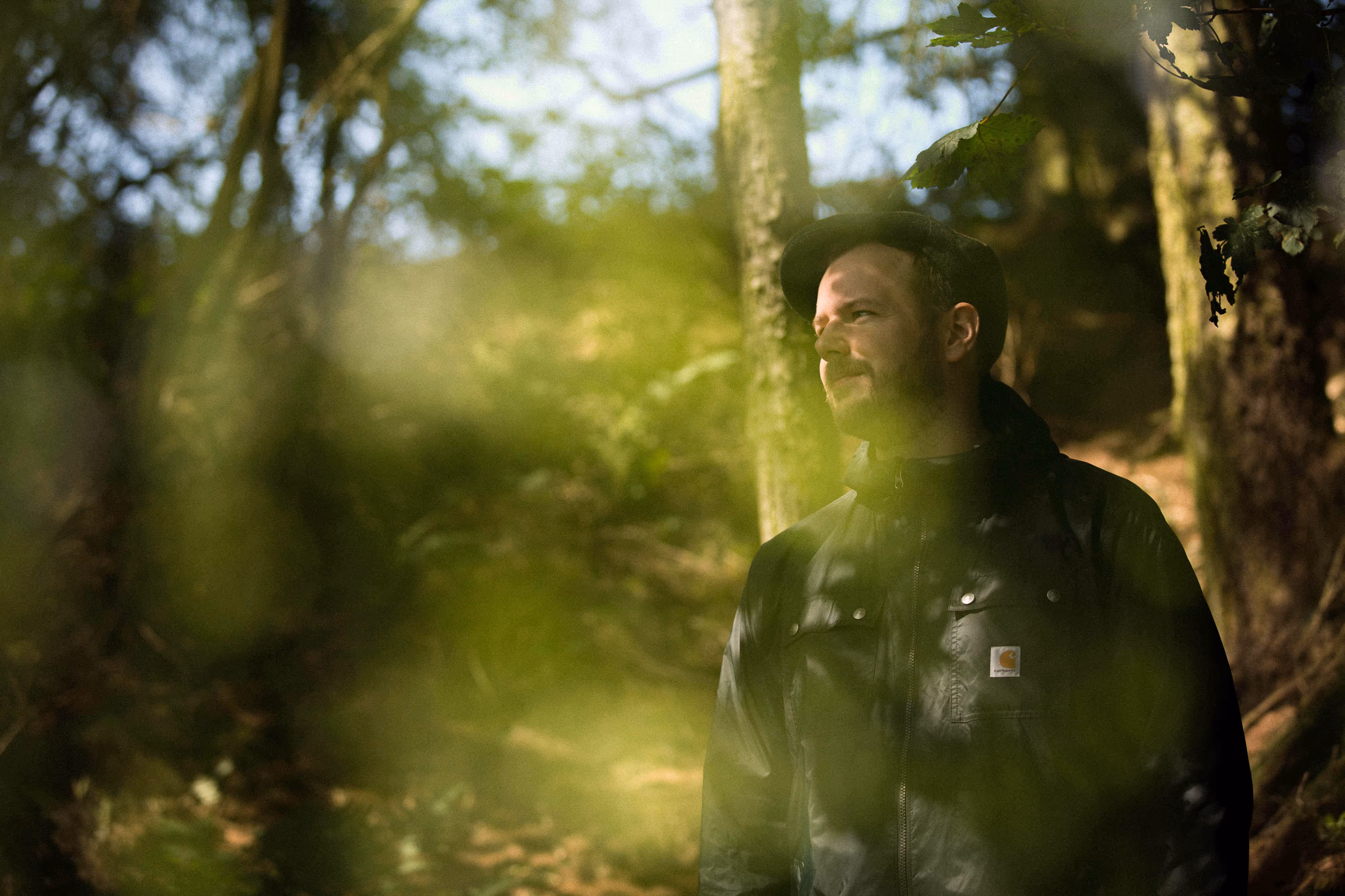 professional musican standing in woods