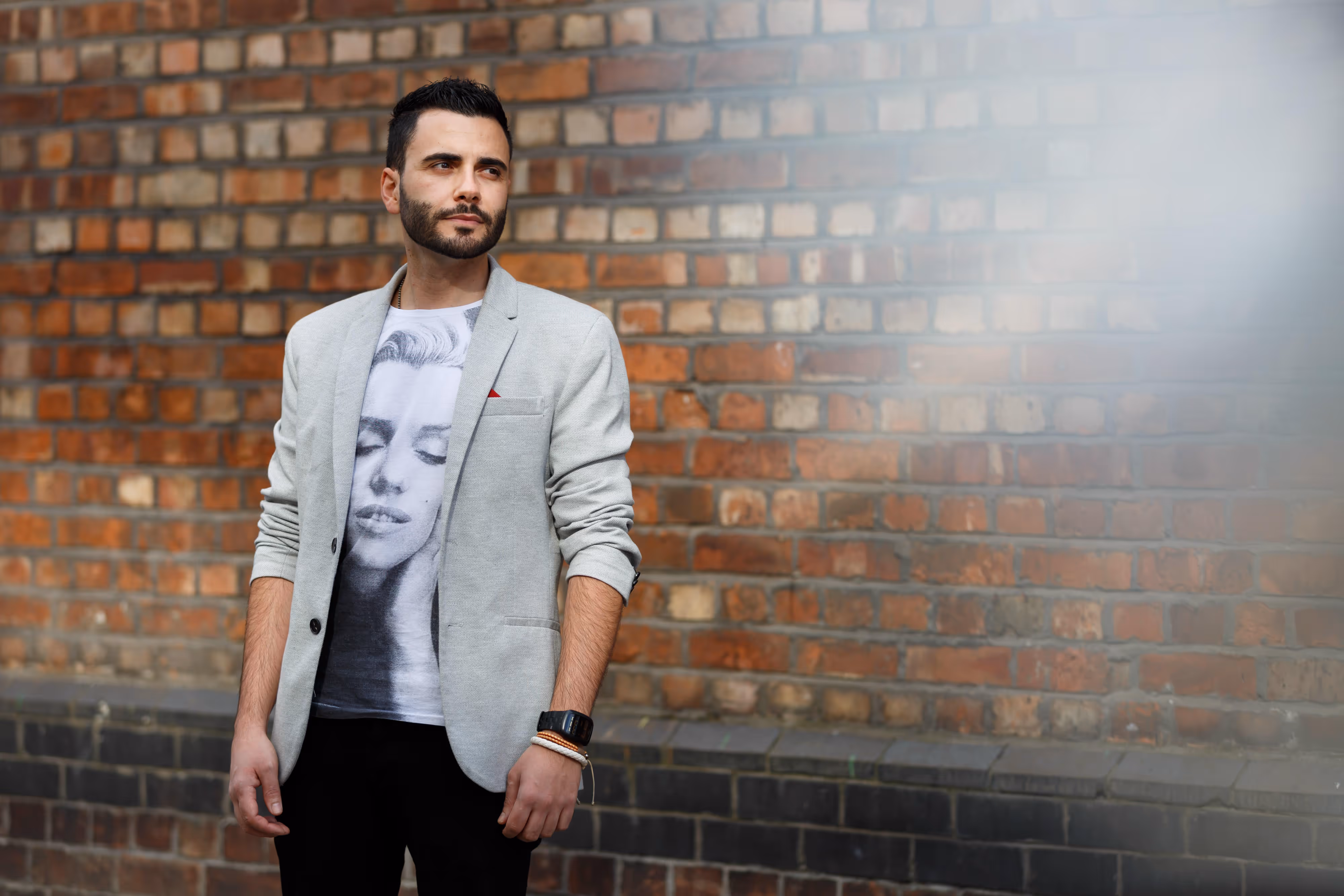 house dj in front of brick wall with refraction effect