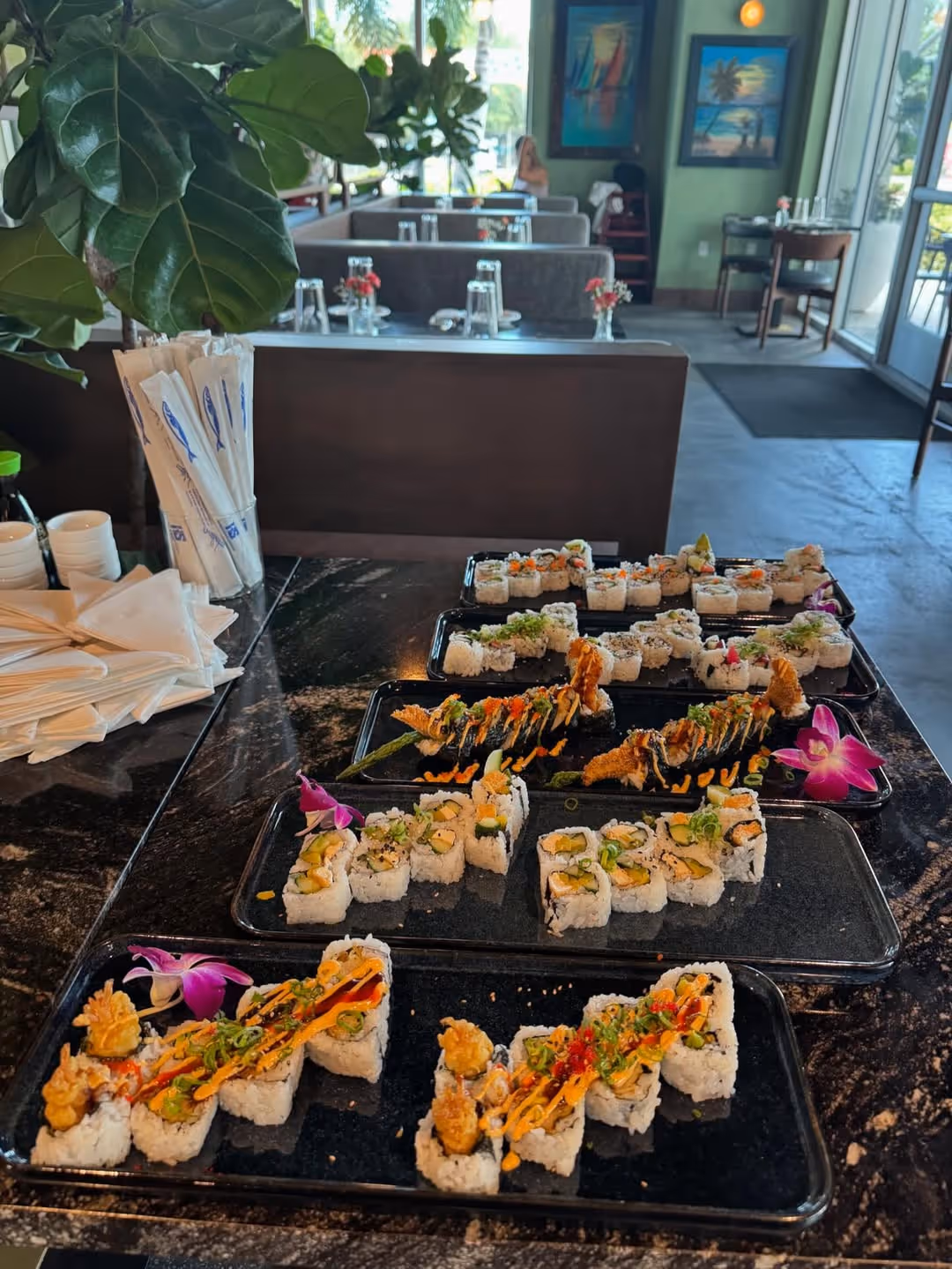 A table with a variety of sushi rolls on it.