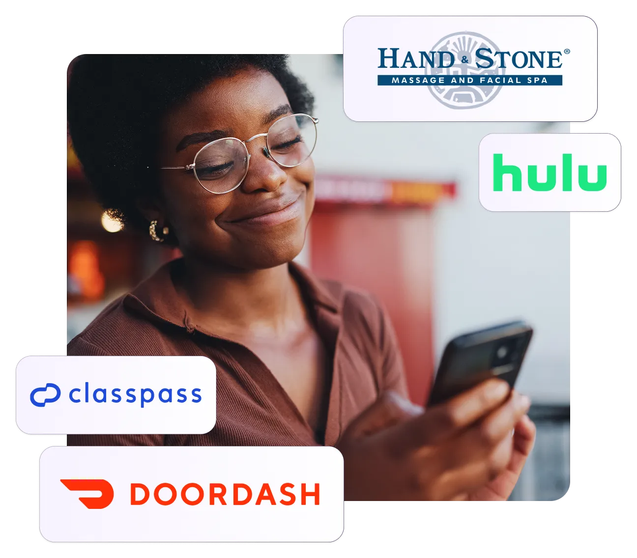 A woman wearing glasses looking at her cell phone.