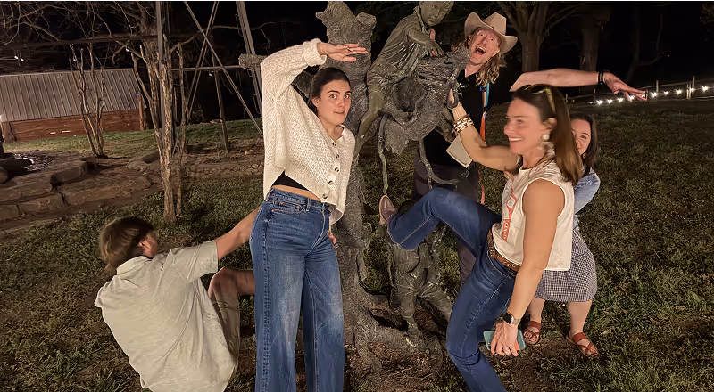 Group of friends laughing and dancing outdoors at night