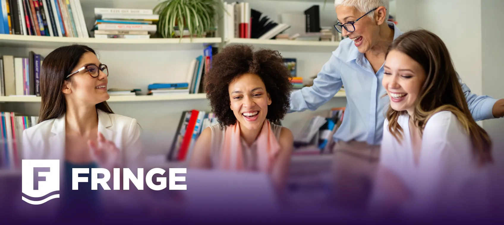 Four diverse women smiling and engaging together in a bright office with bookshelves in the background, with the Fringe logo overlayed at the bottom left.