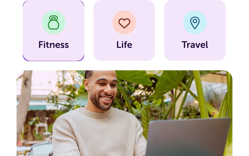 Smiling man in a beige sweater using a laptop outdoors with green plants around; icons above label Fitness, Life, and Travel.