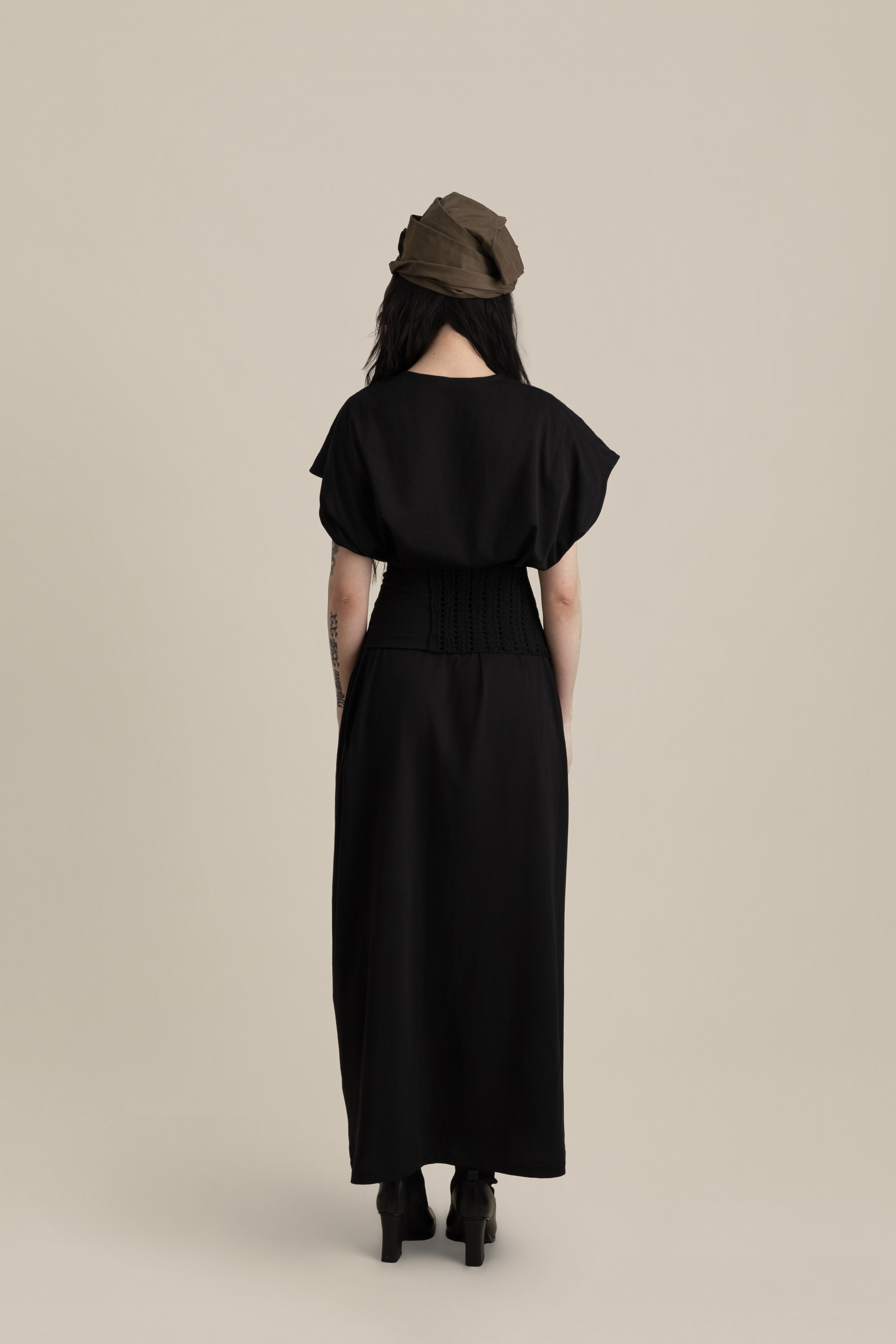 Back view of male model walking away wearing dark Light U-neck Tunic and brown Cowboy Pants in soft warm light, Oniri editorial aesthetic