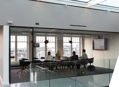 a group of people sitting at a table in an office