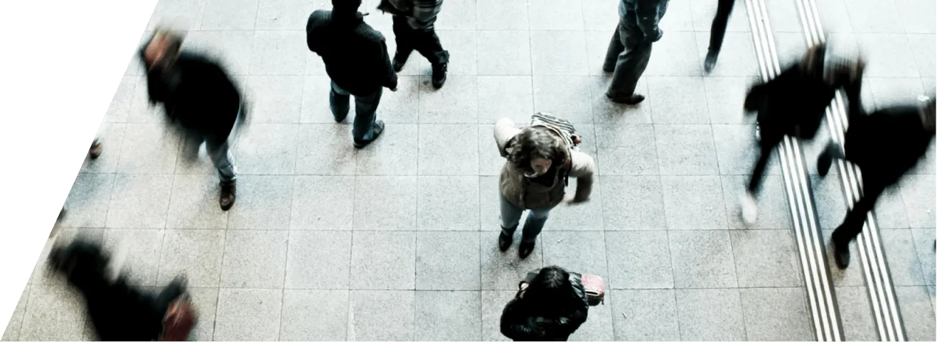 a group of people walking down a sidewalk