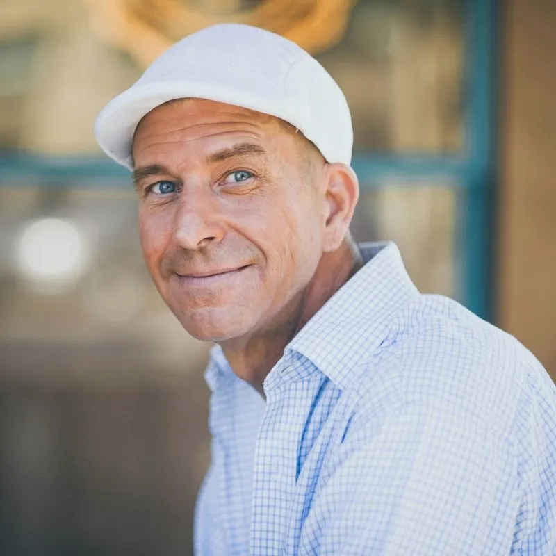 a man wearing a white hat and a blue shirt
