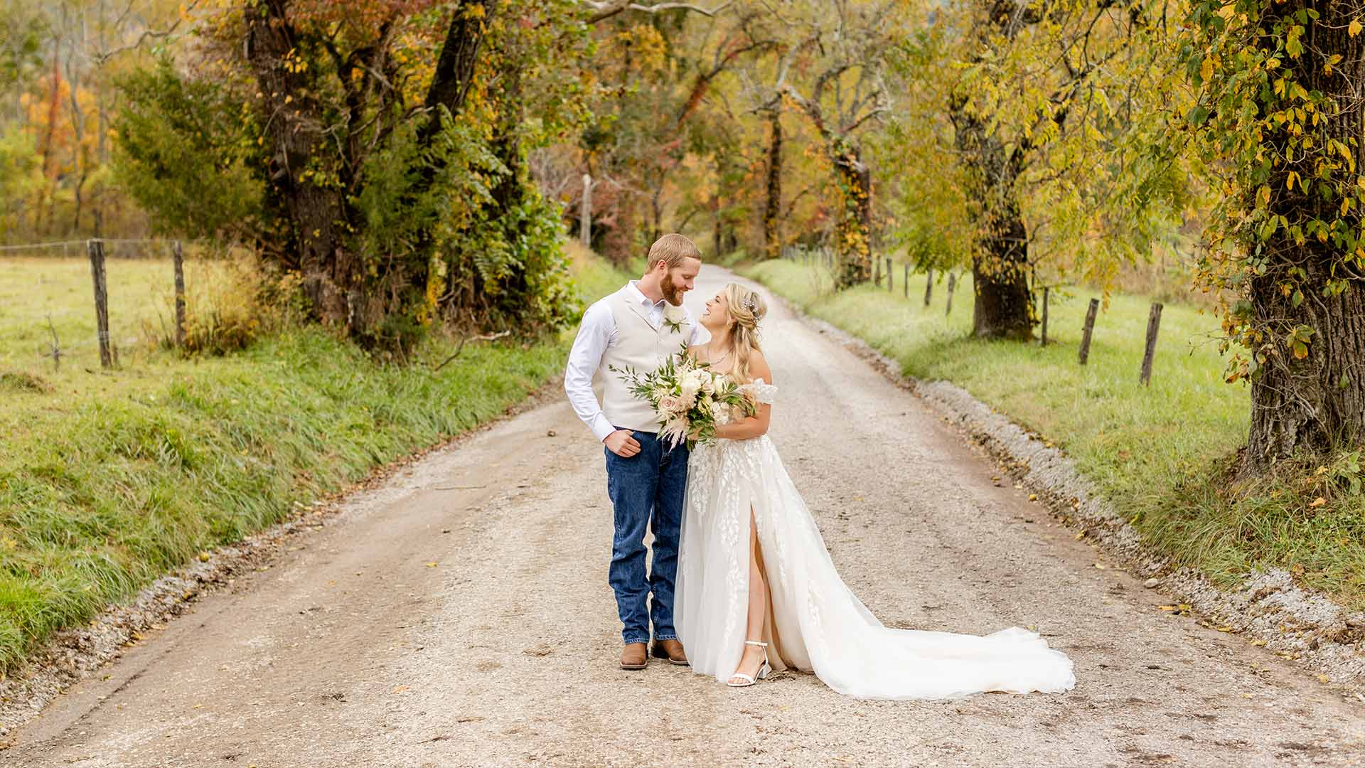 Couple posing for wedding photos in Cades Cove, Tennessee by Let's Elope Gatlinburg.