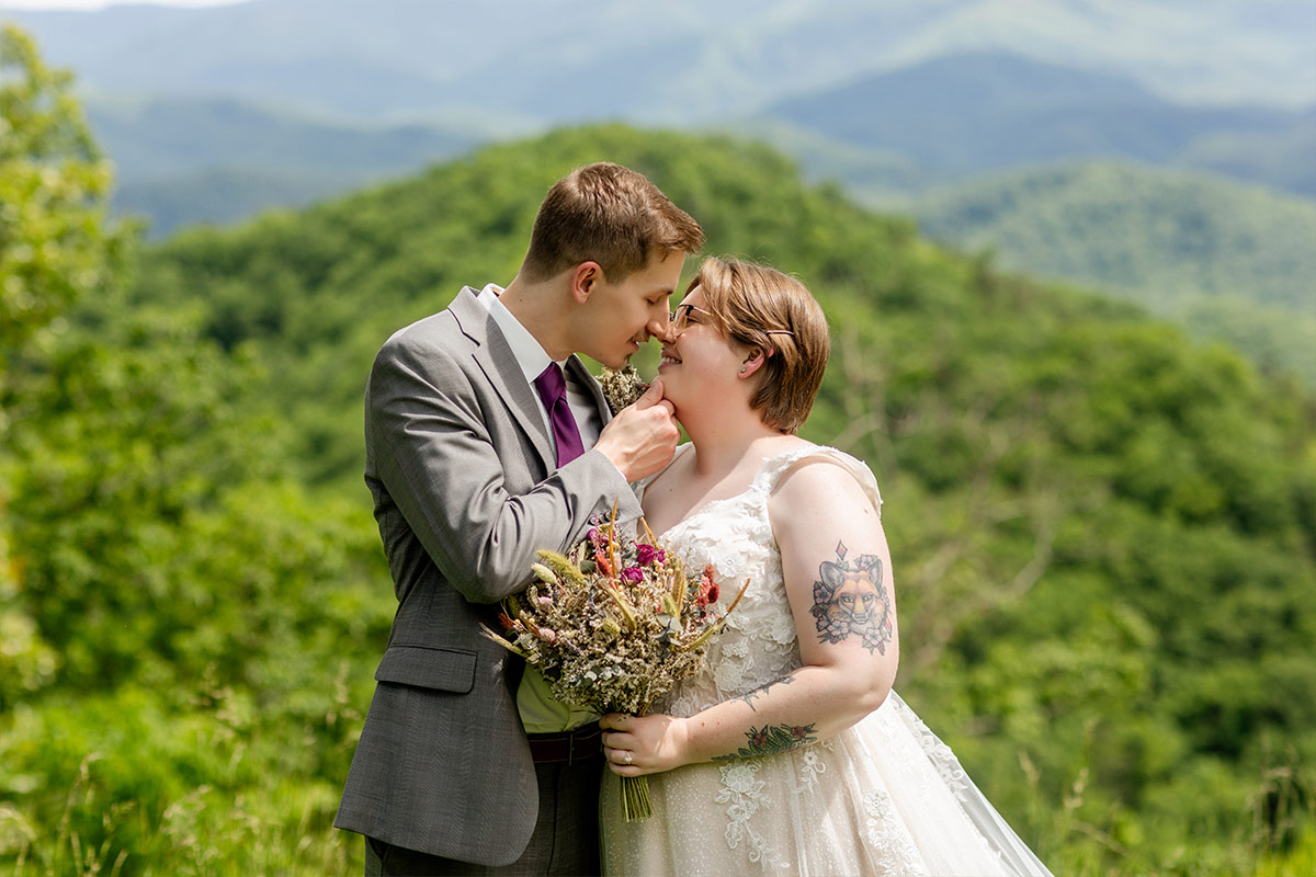 Photograph by Let's Elope Gatlinburg of a couple who just eloped embracing in the Smoky Mountains of Tennessee.
