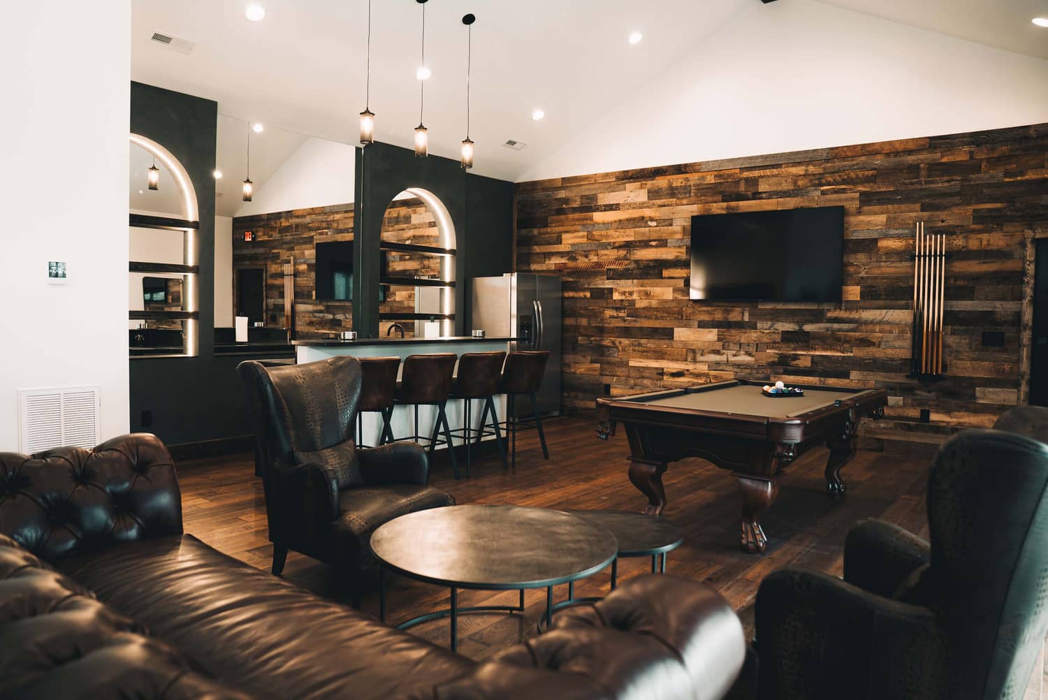 Cozy grooms lounge area with wooden accents, a bar, and comfortable seating, ideal for elopements in Gatlinburg.