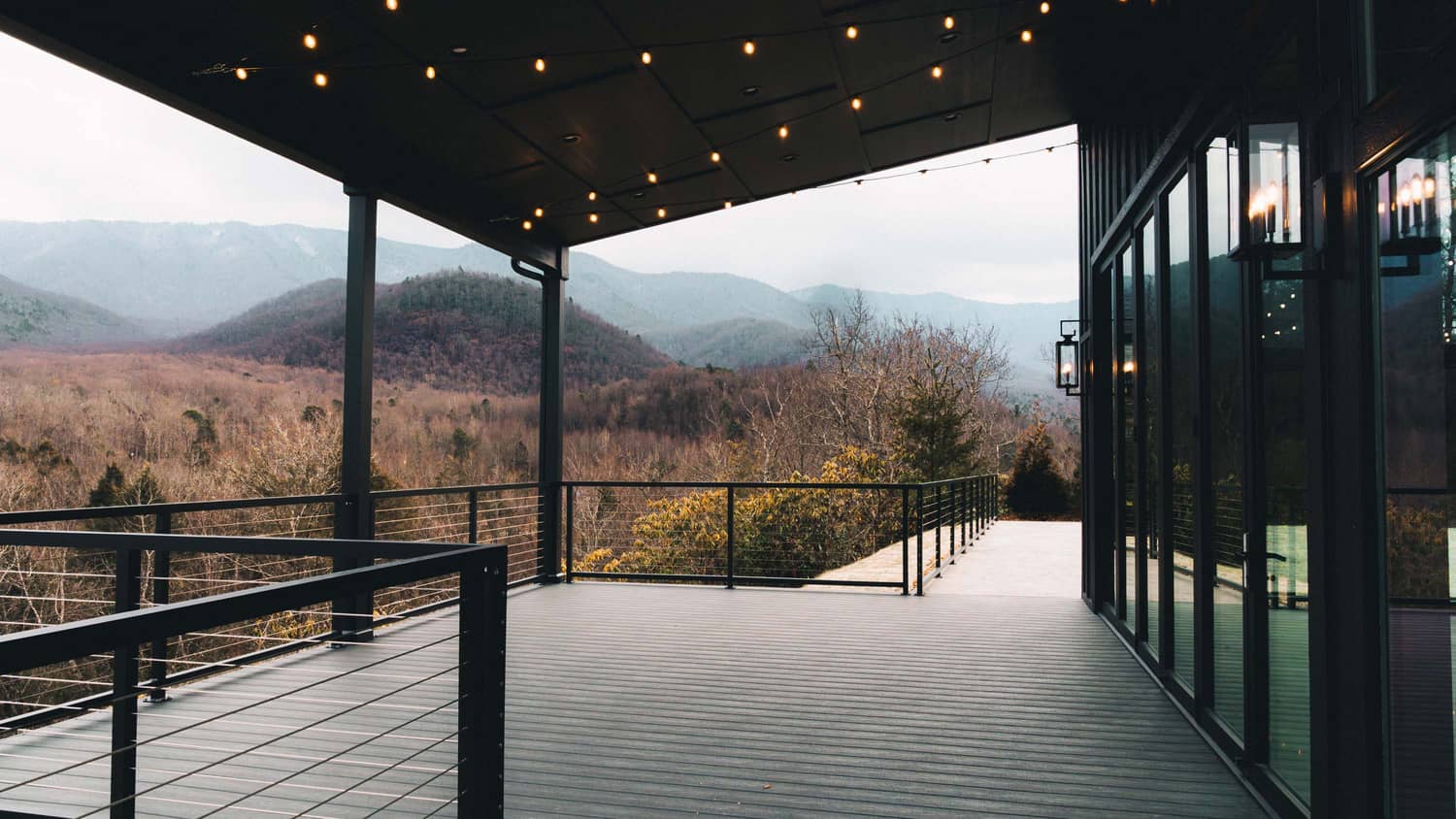 Modern outdoor venue with mountain views, featuring a spacious deck and string lights, ideal for elopements in Gatlinburg.