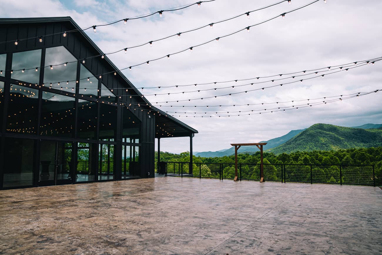 Trailhead Venues Grand Hall building with large glass windows, surrounded by trees, ideal for elopements in the Smoky Mountains.