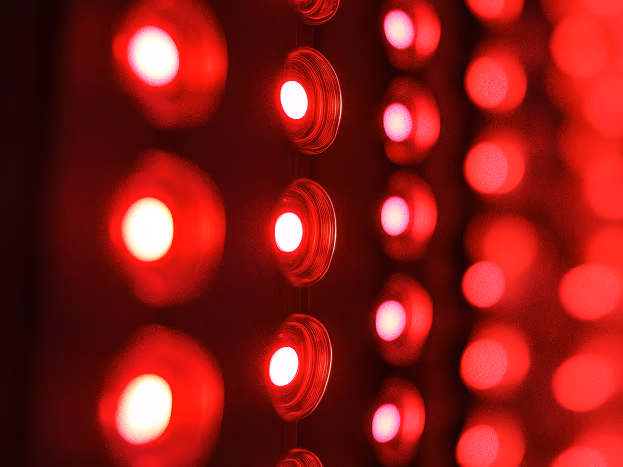Red light panel illuminating full-body, FDA registered and clinical graded, red and near-infrared light therapy.