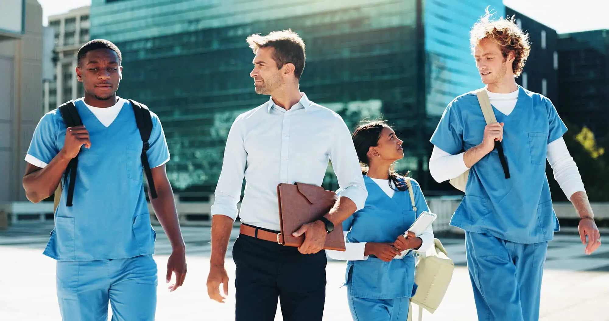 group of professional nurses walking in city