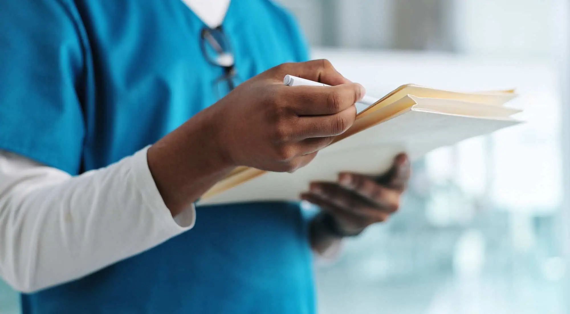 healthcare nurse holding patient documents