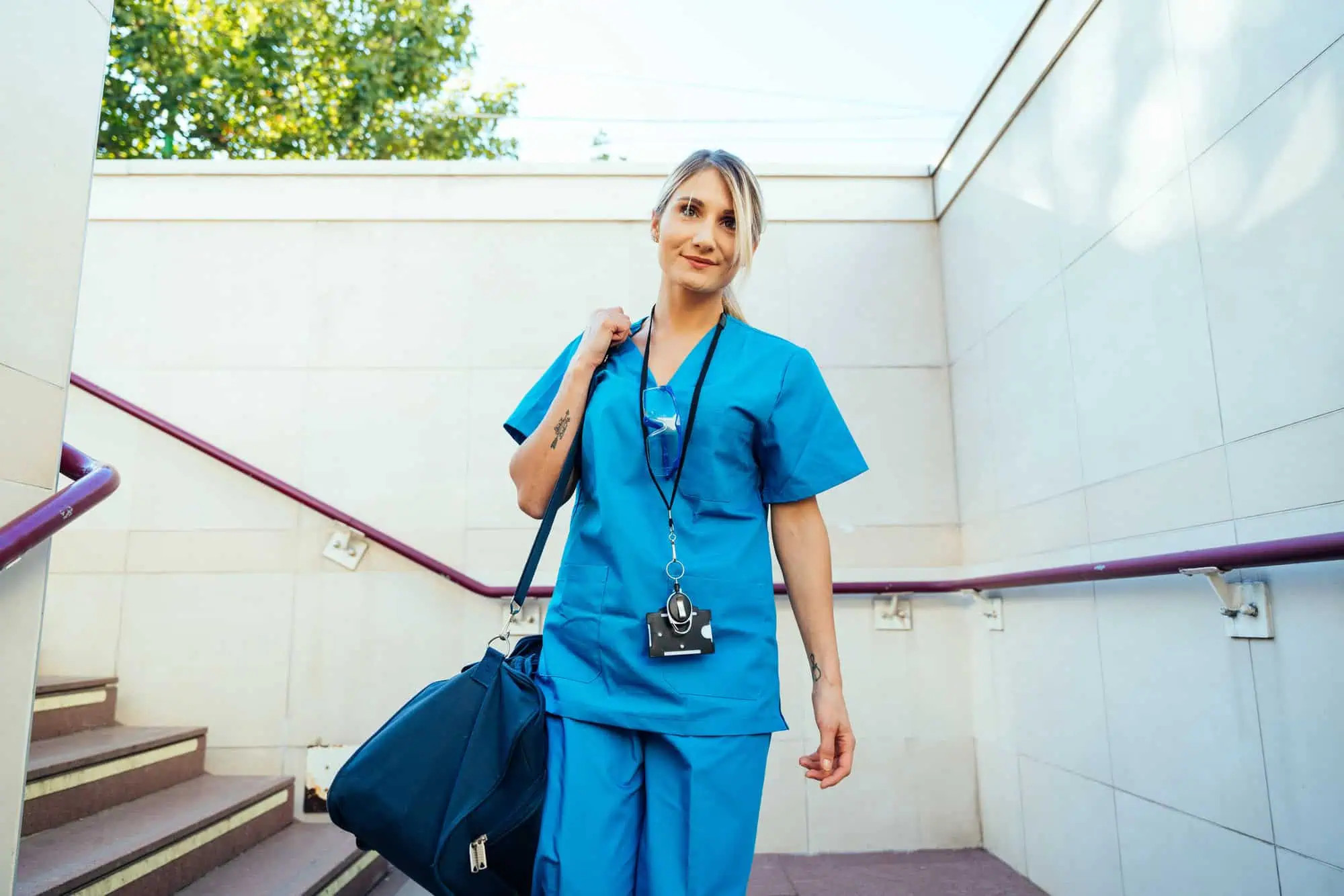 nurse walking with duffel bag