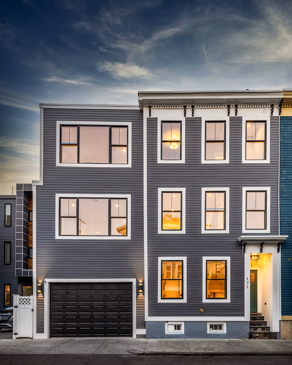 Newly built gray townhouse exterior with garage – real estate photography