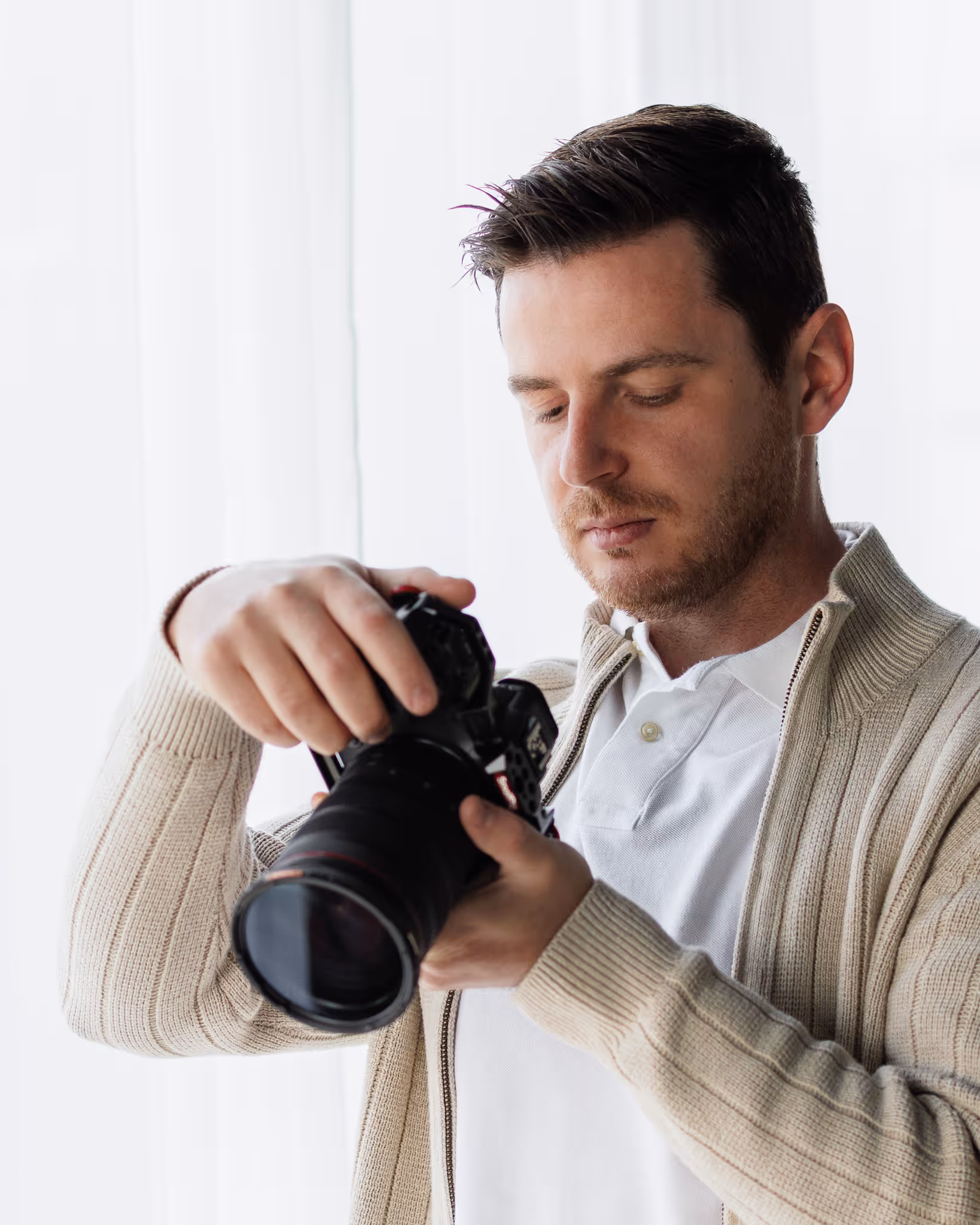 Ovi Mustea adjusting camera settings during a photoshoot in Boston