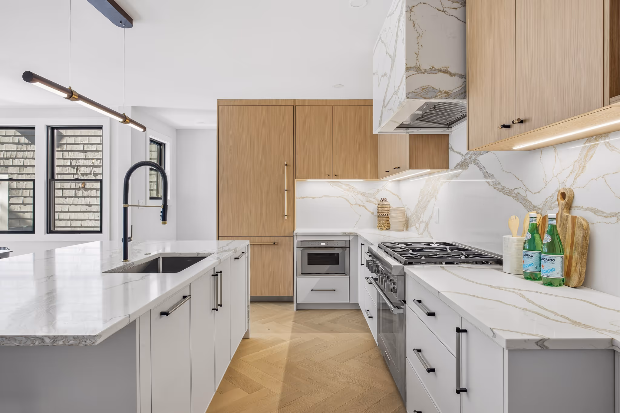 Modern kitchen with breakfast bar and open staircase design.