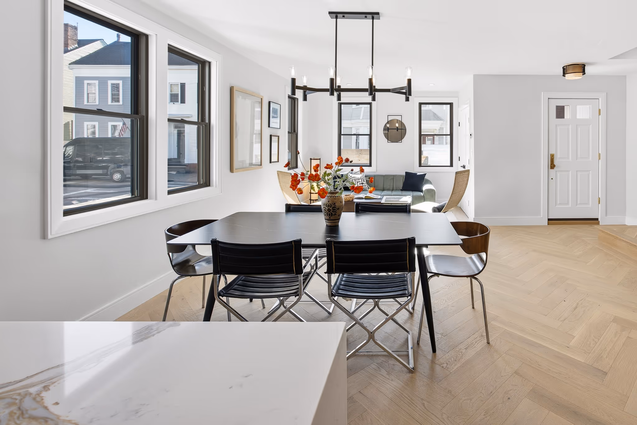 Dining area featuring pendant lights and large windows.