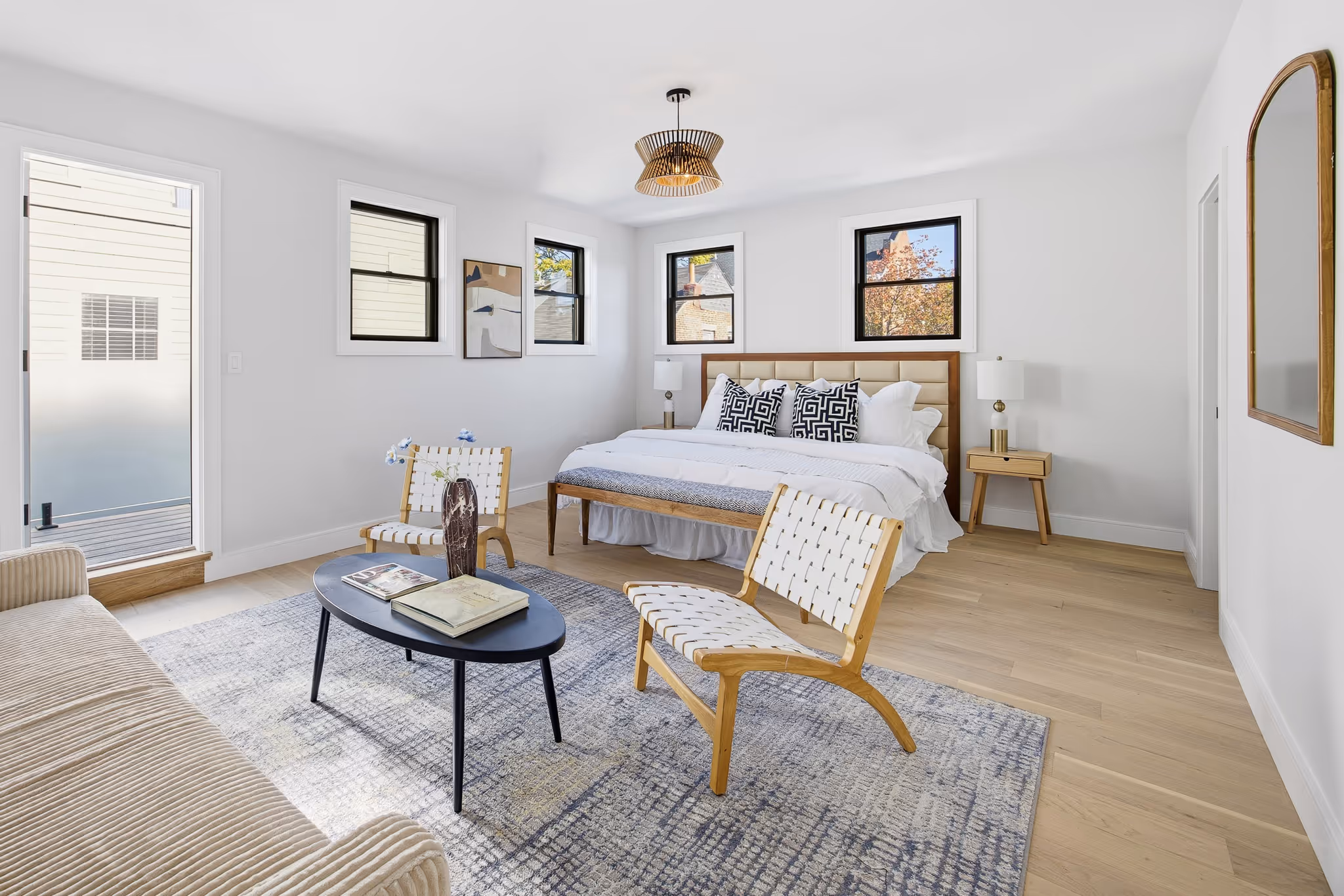 Bright bedroom with neutral tones, wall art, and modern furniture.