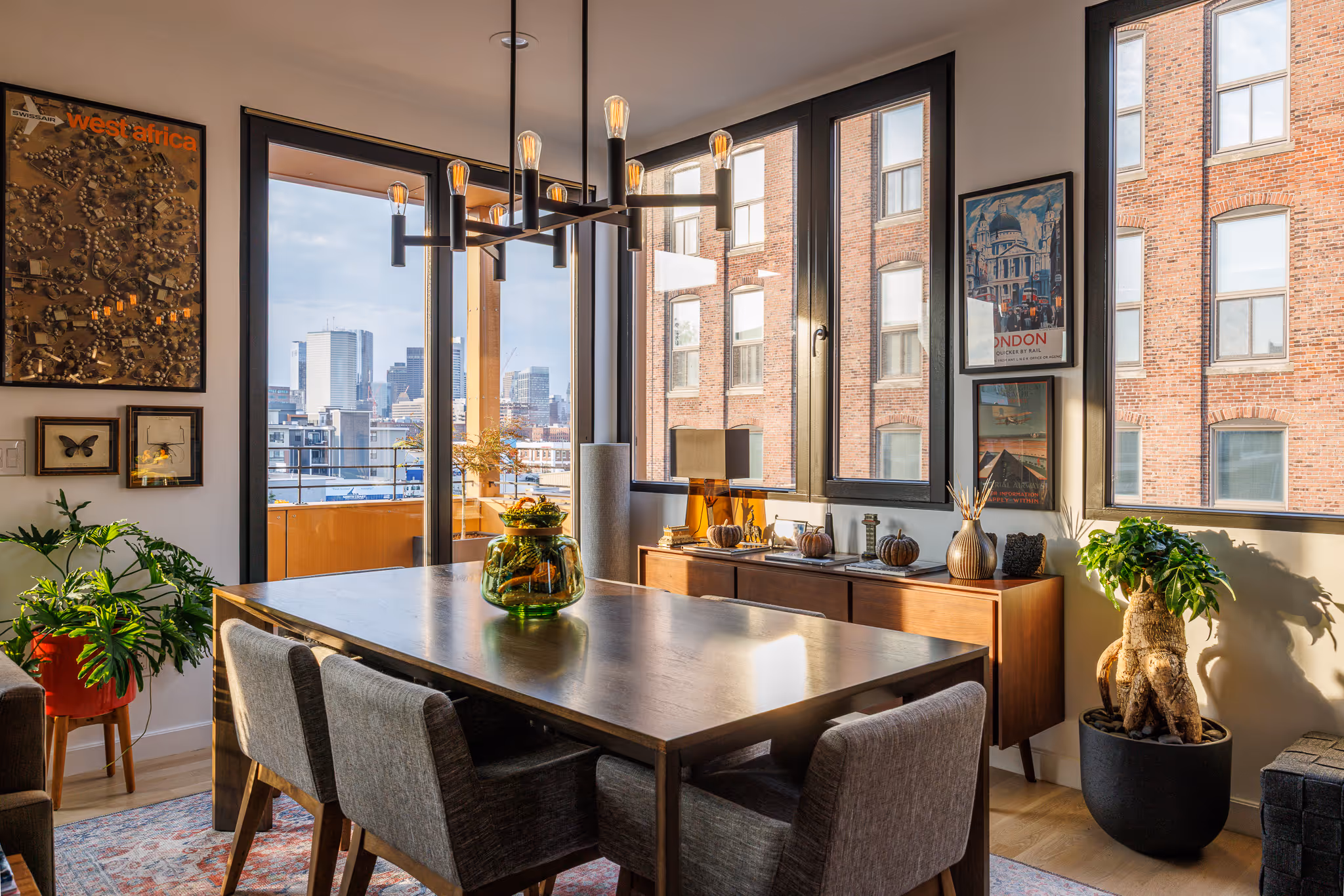 Bright dining area with large windows and skyline views.