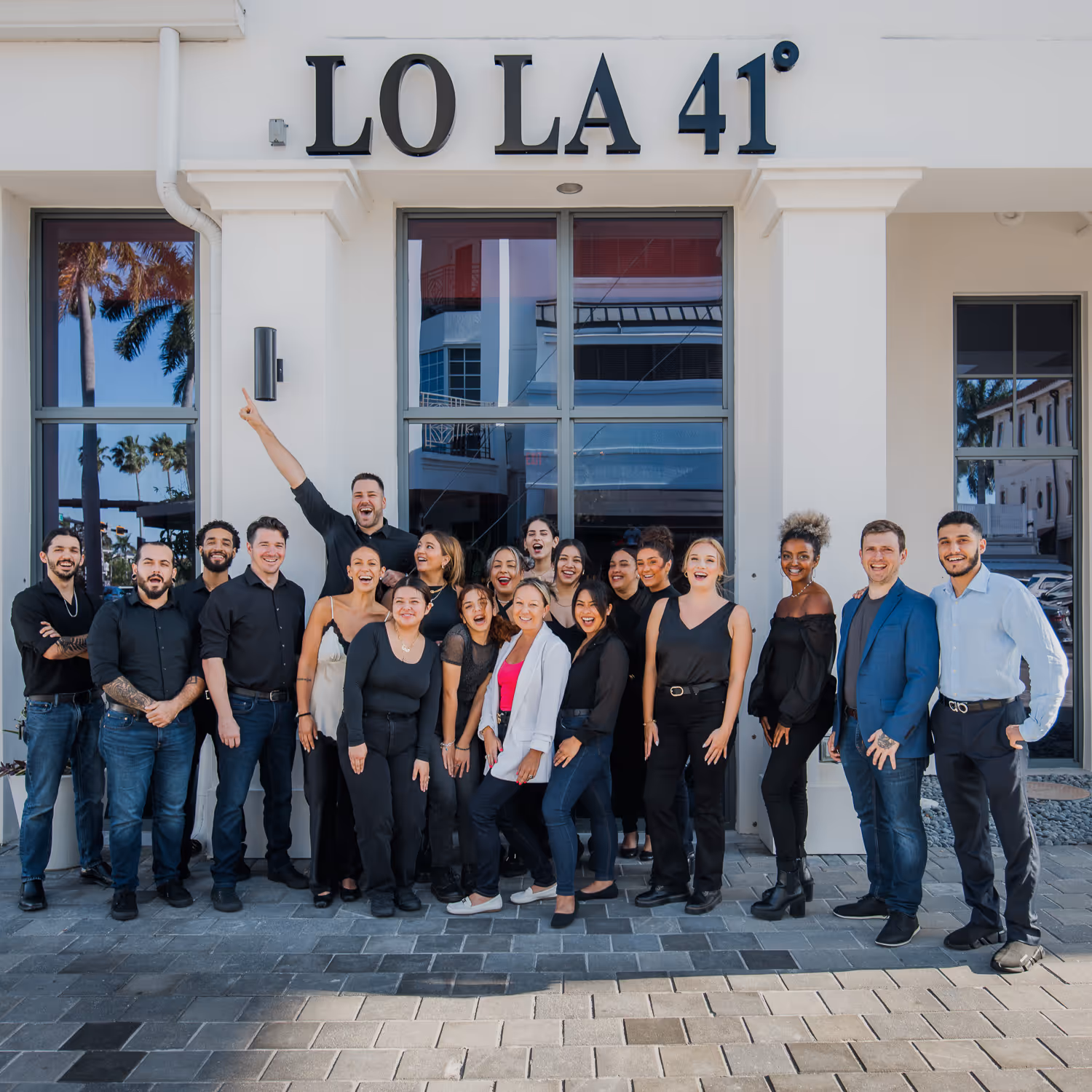 Group photo of Lola 41 team taken by Boston event photographer outside the restaurant.