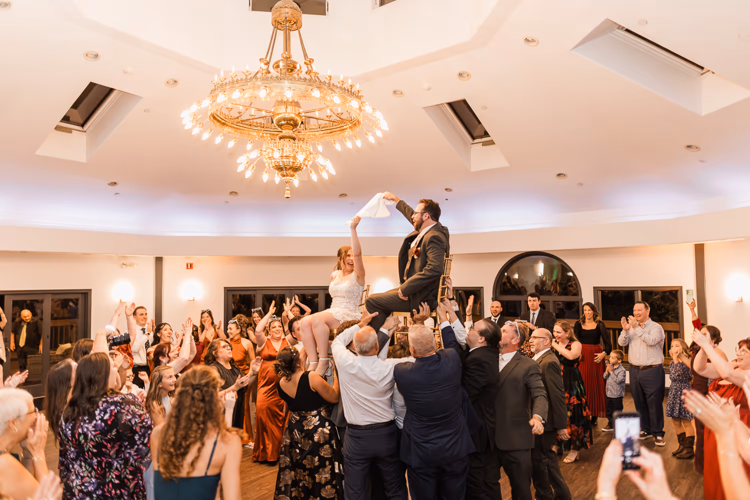 Elegant ballroom celebration photographed by Boston event photographer with guests dancing.