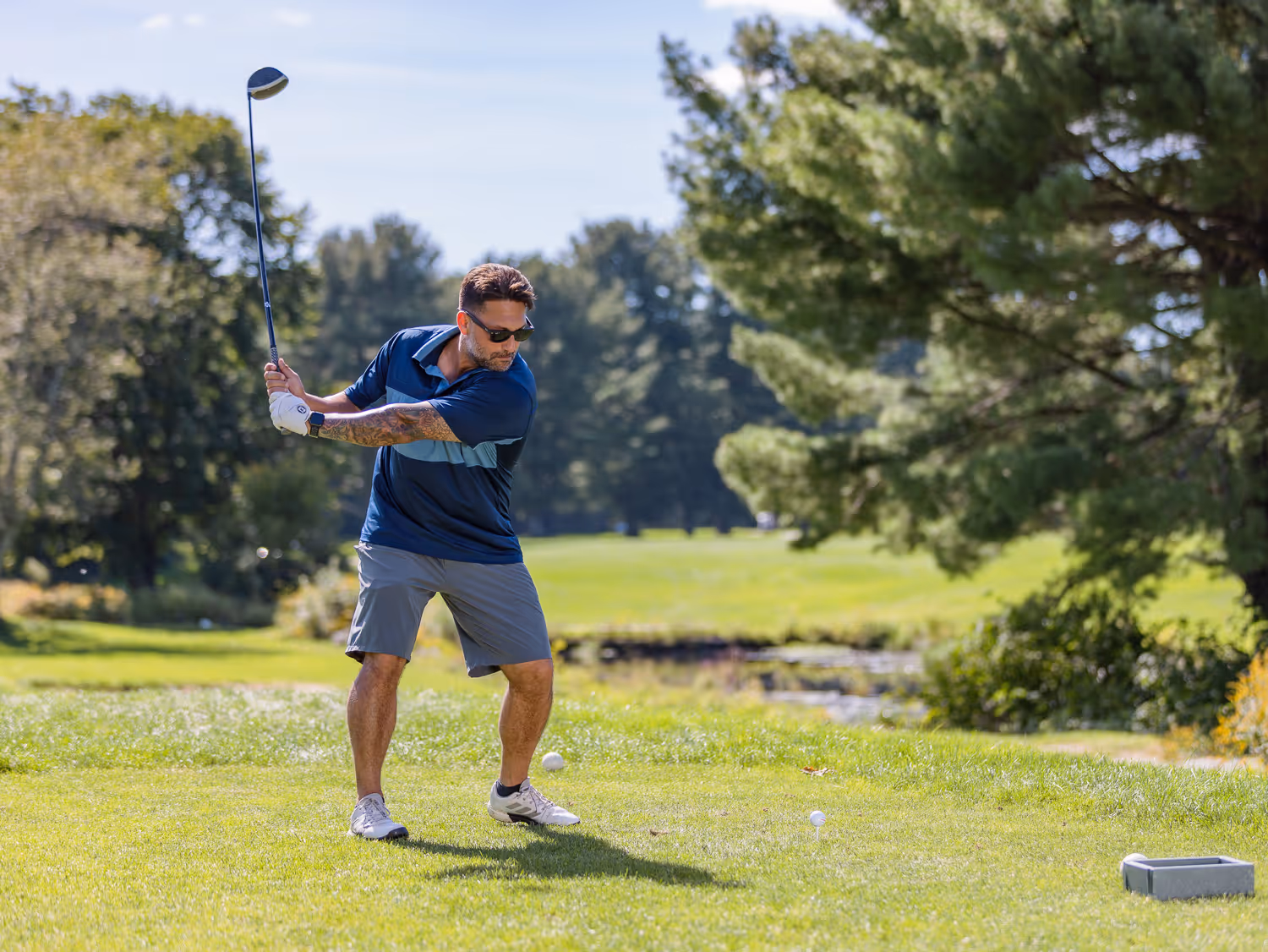 Golfer swinging at a Boston charity event photographed by Boston event photographer.