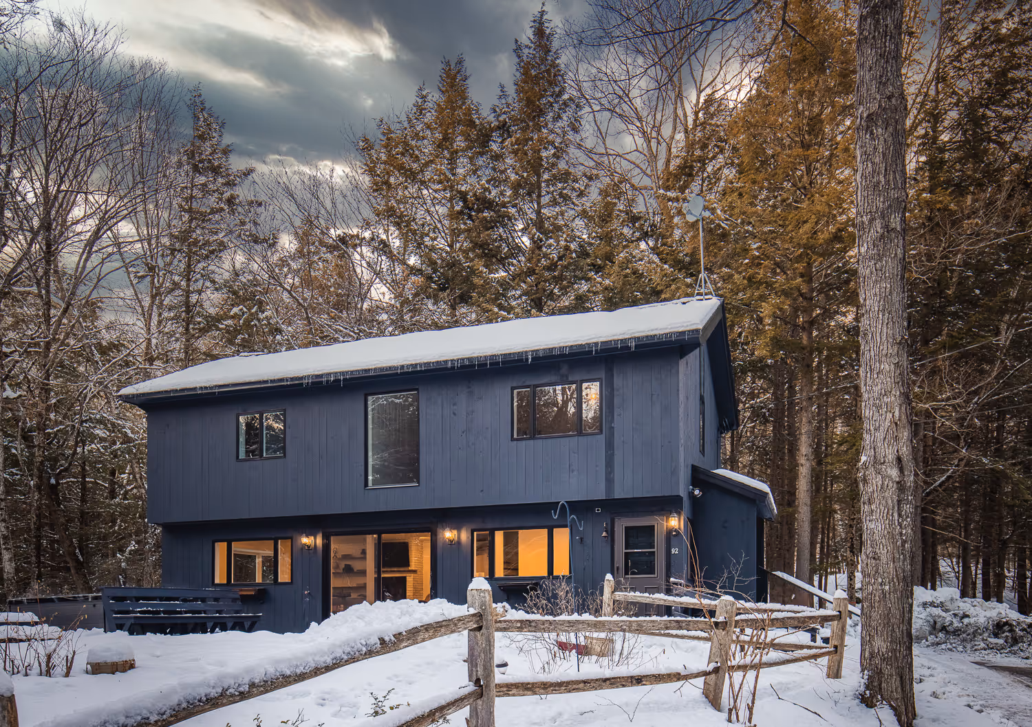 Modern black cabin exterior in snow — Vermont Airbnb photographer winter cabin