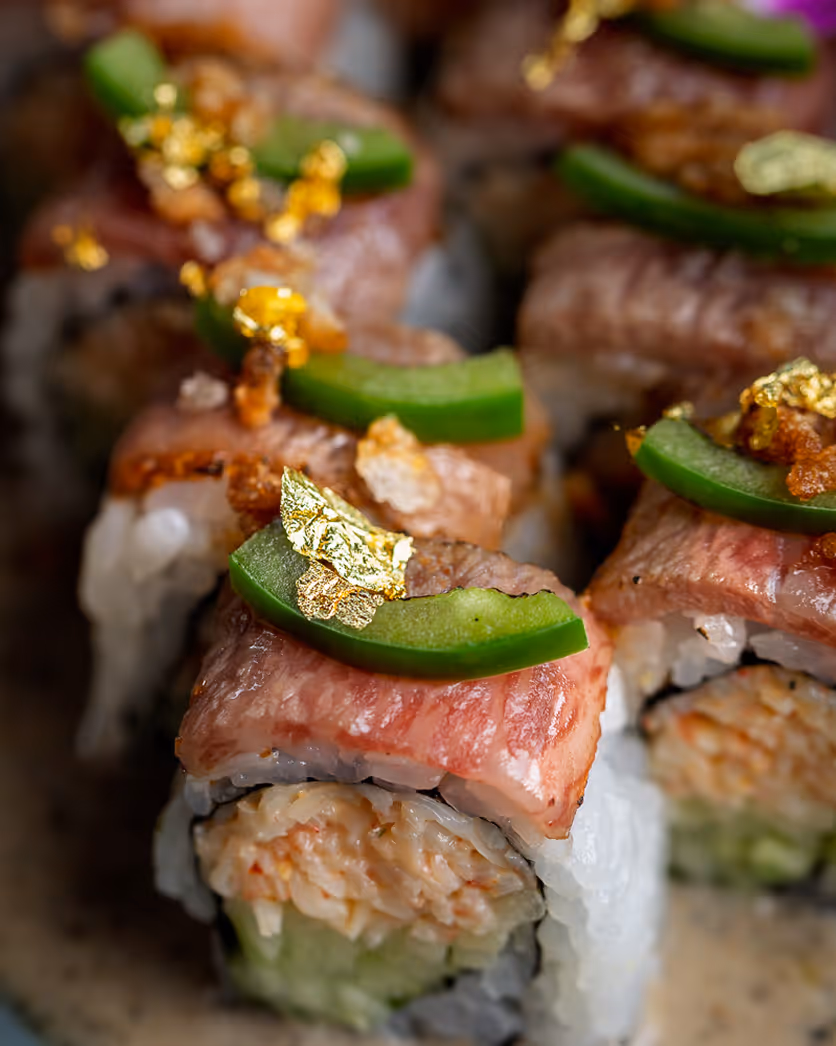 Boston food photographer capturing sushi rolls topped with jalapeño and sauce for restaurant menu and social media.
