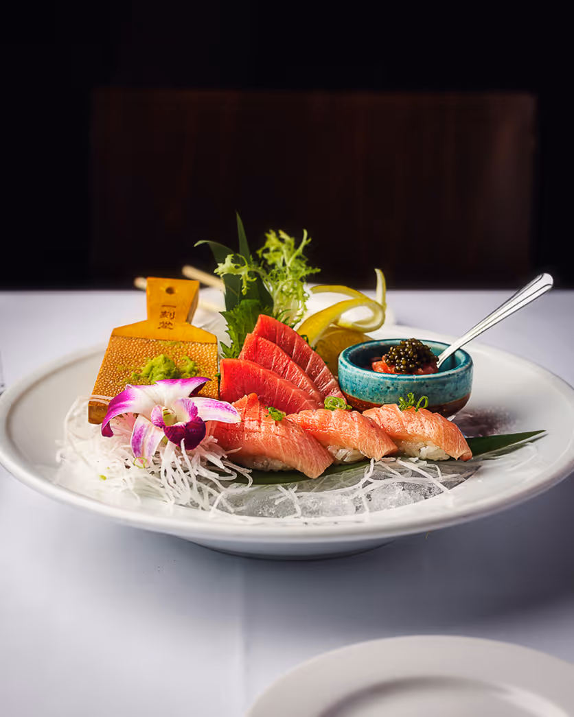 Boston restaurant photographer photo of sushi and sashimi platter with artistic plating and fresh ingredients.