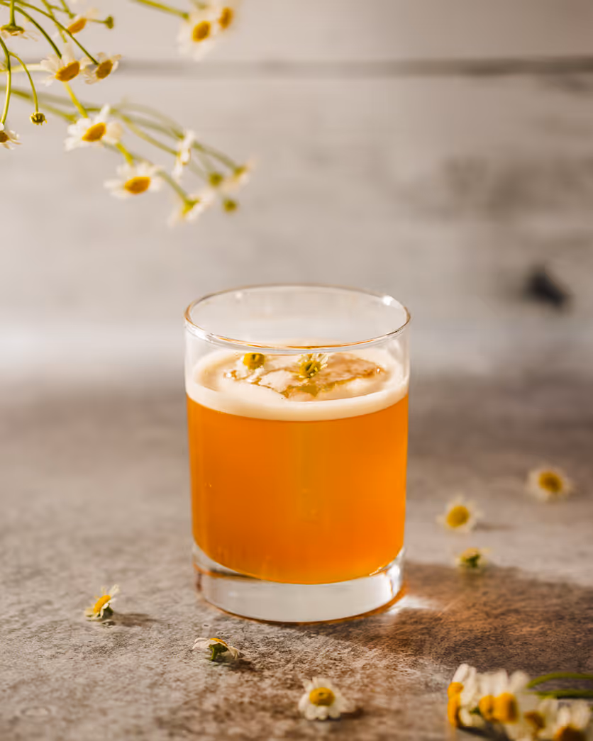 Craft cocktail with floral garnish shot by Boston food photographer, highlighting restaurant drink photography lighting.