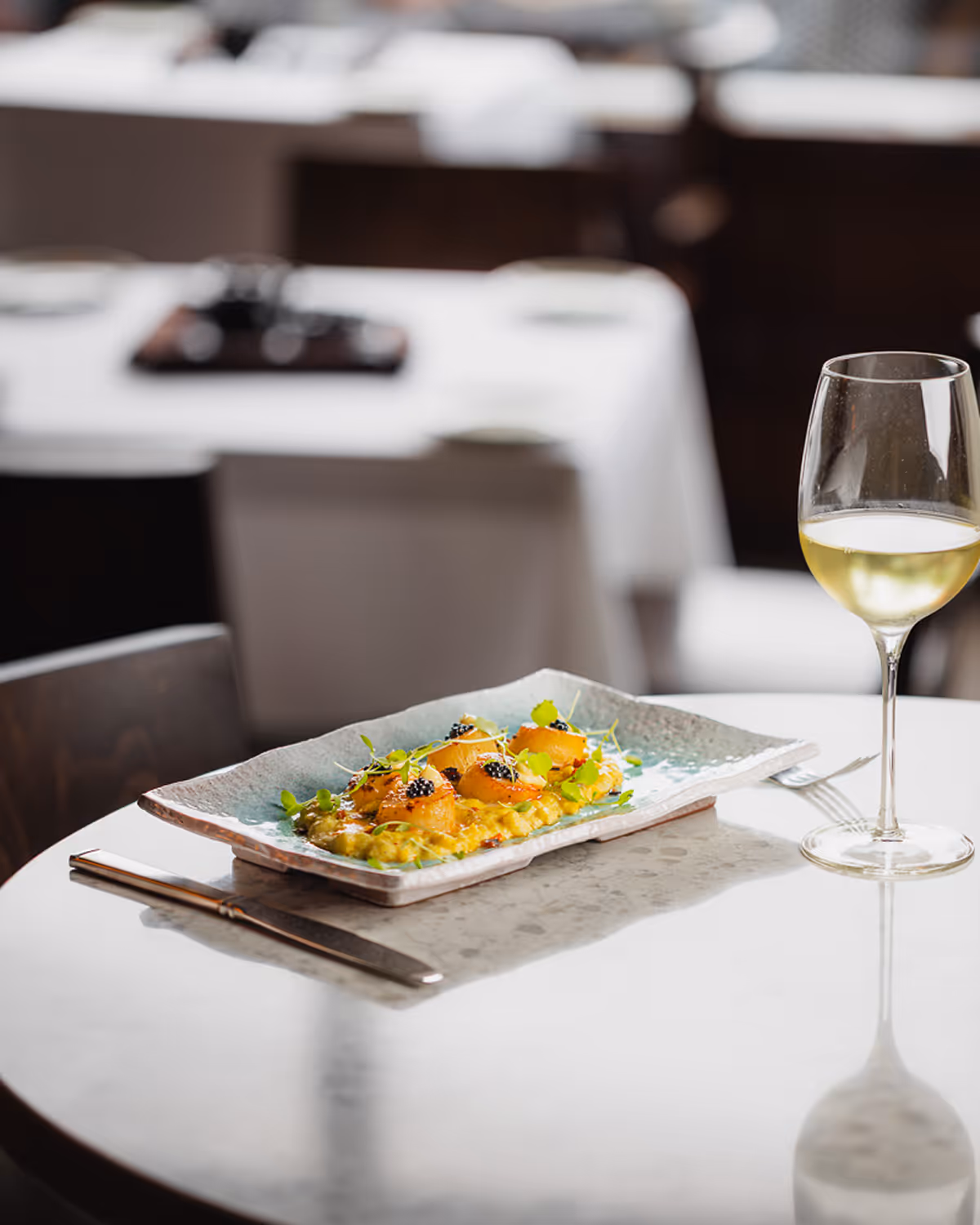 Elegant seafood dish with white wine – Boston restaurant photographer.