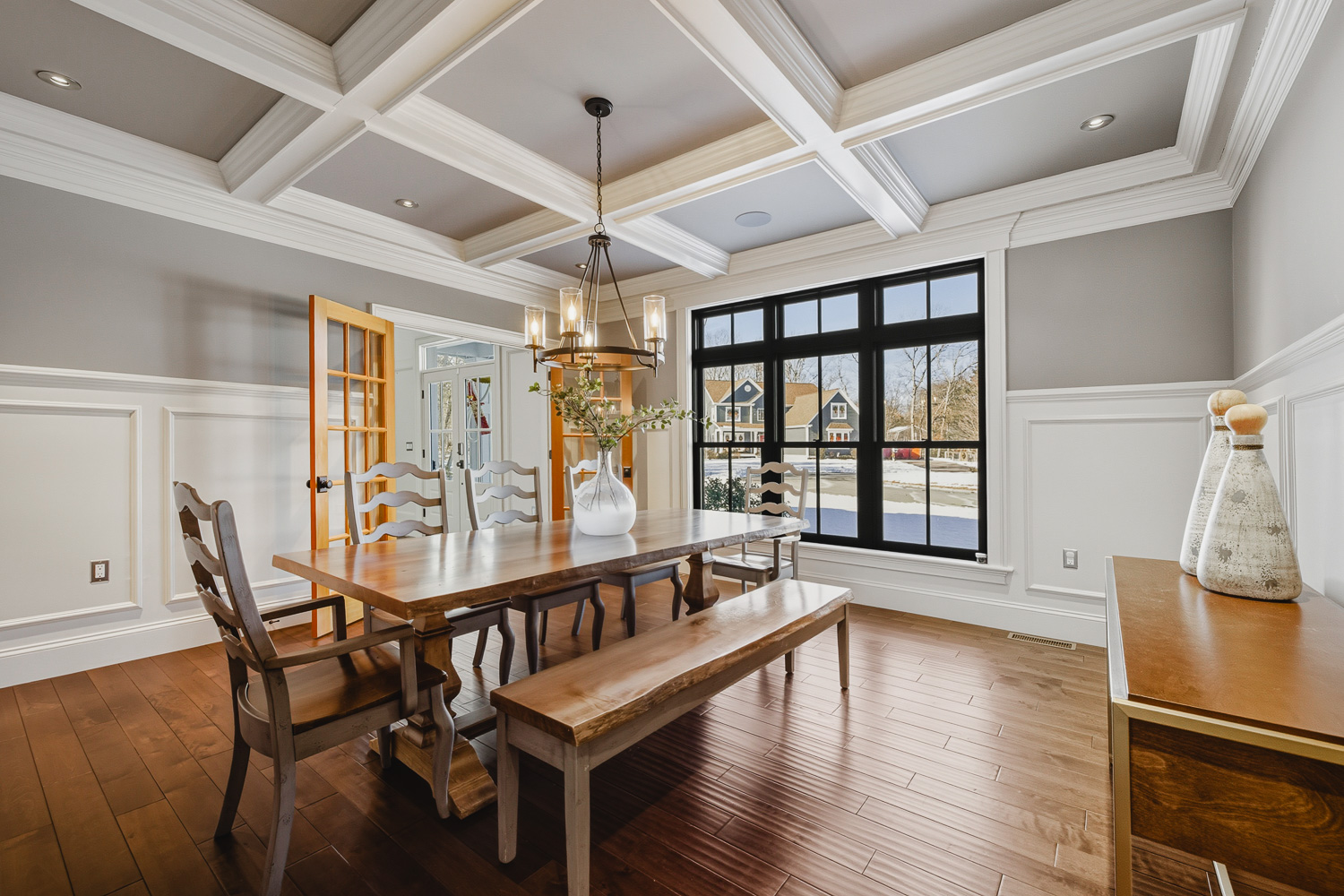 Formal dining room with coffered ceiling and large windows in Plainville MA.