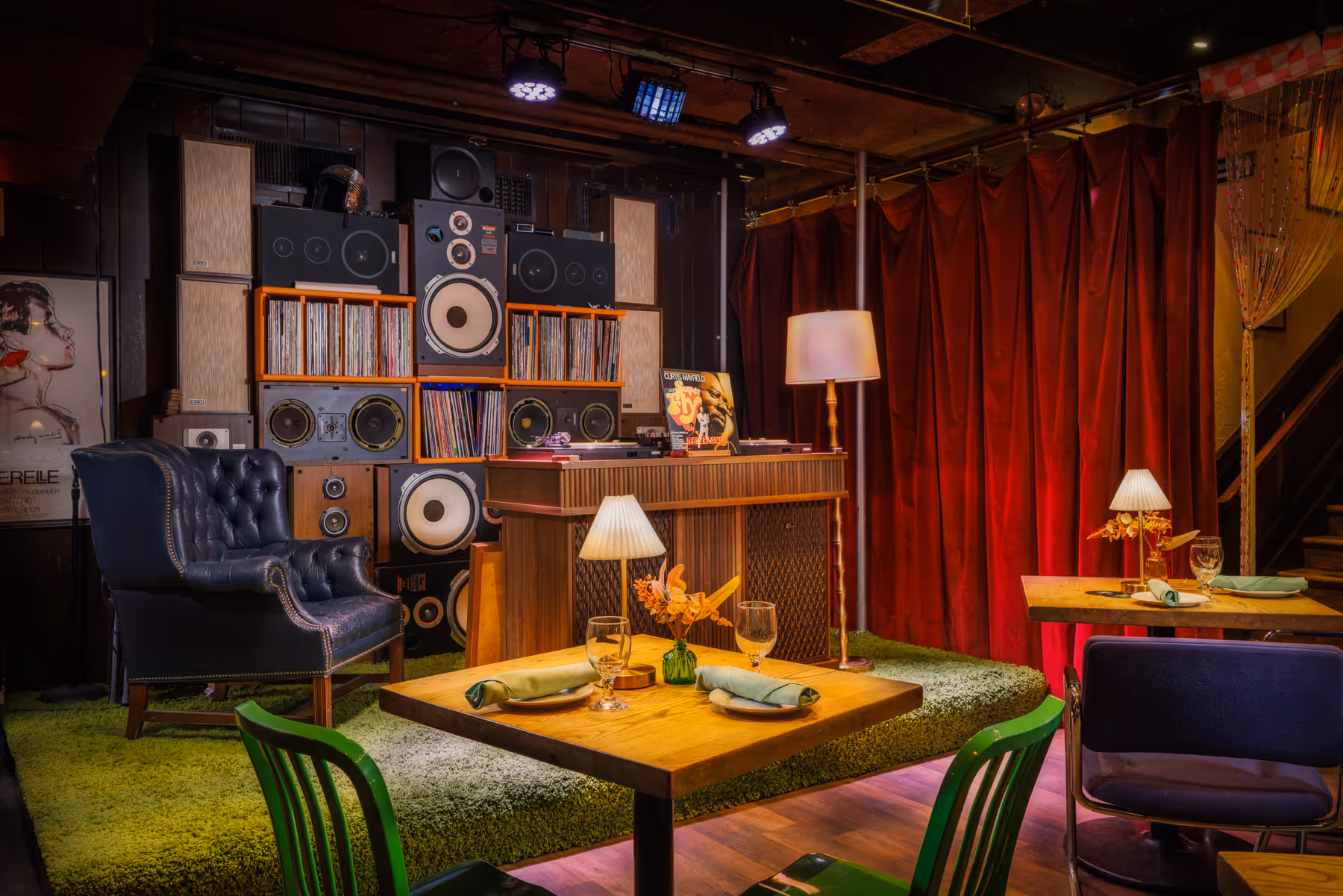 Lounge seating area at Back Bay Social The Retro Room with red curtains, vintage speakers, and wood finishes in Boston MA