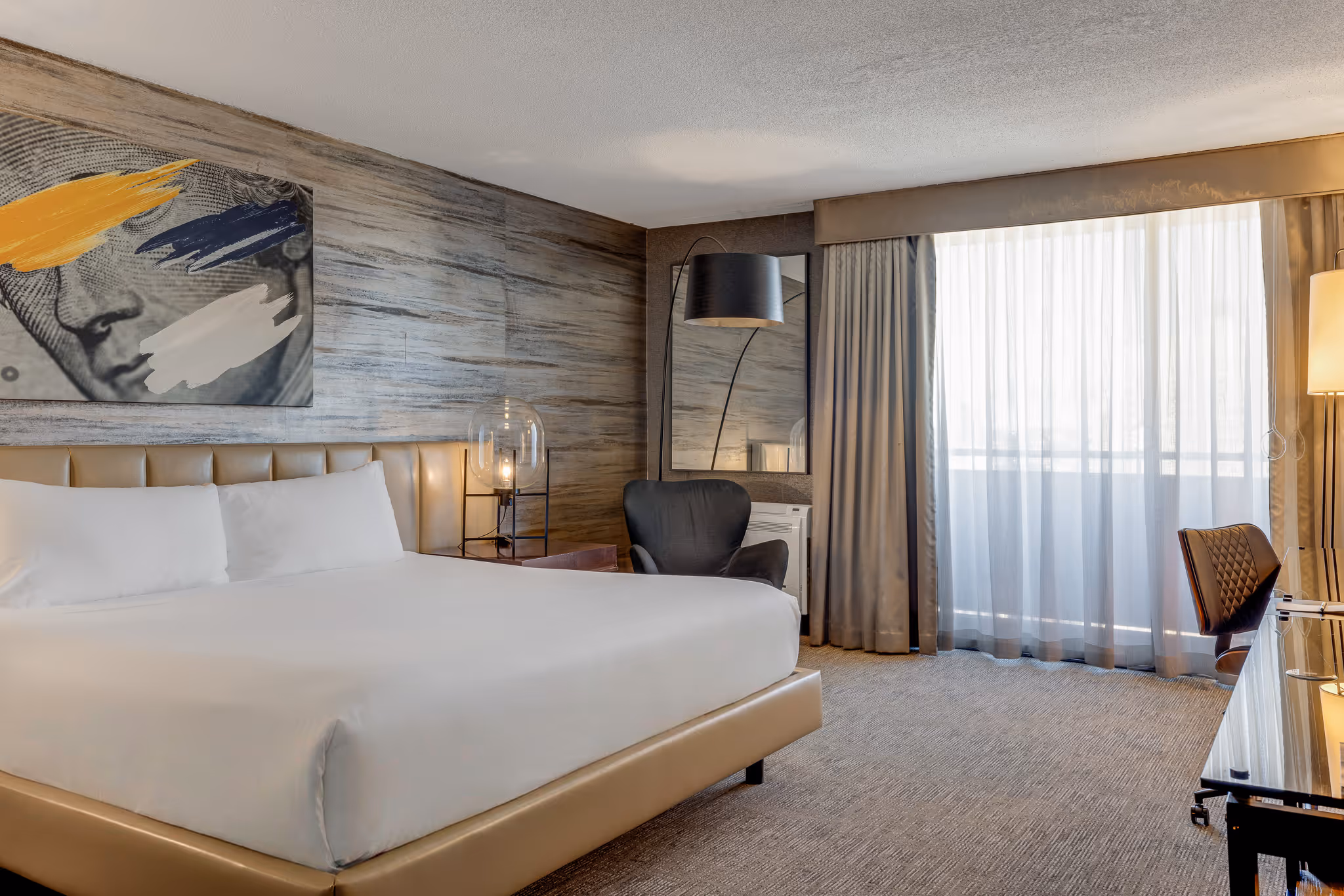 Hotel bedroom with large windows and natural light in Boston