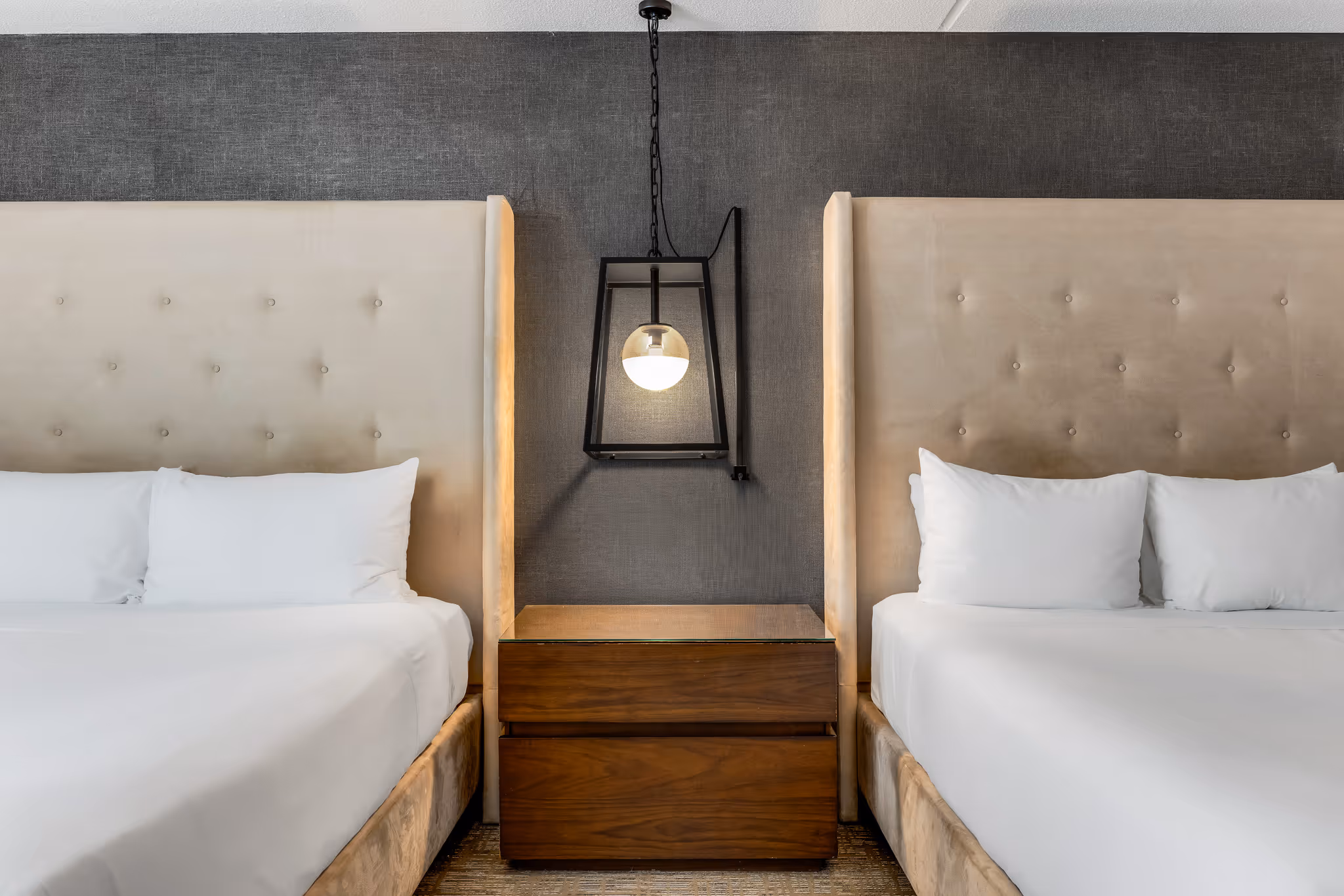 Modern hotel room with two beds and bedside lighting in Boston hotel
