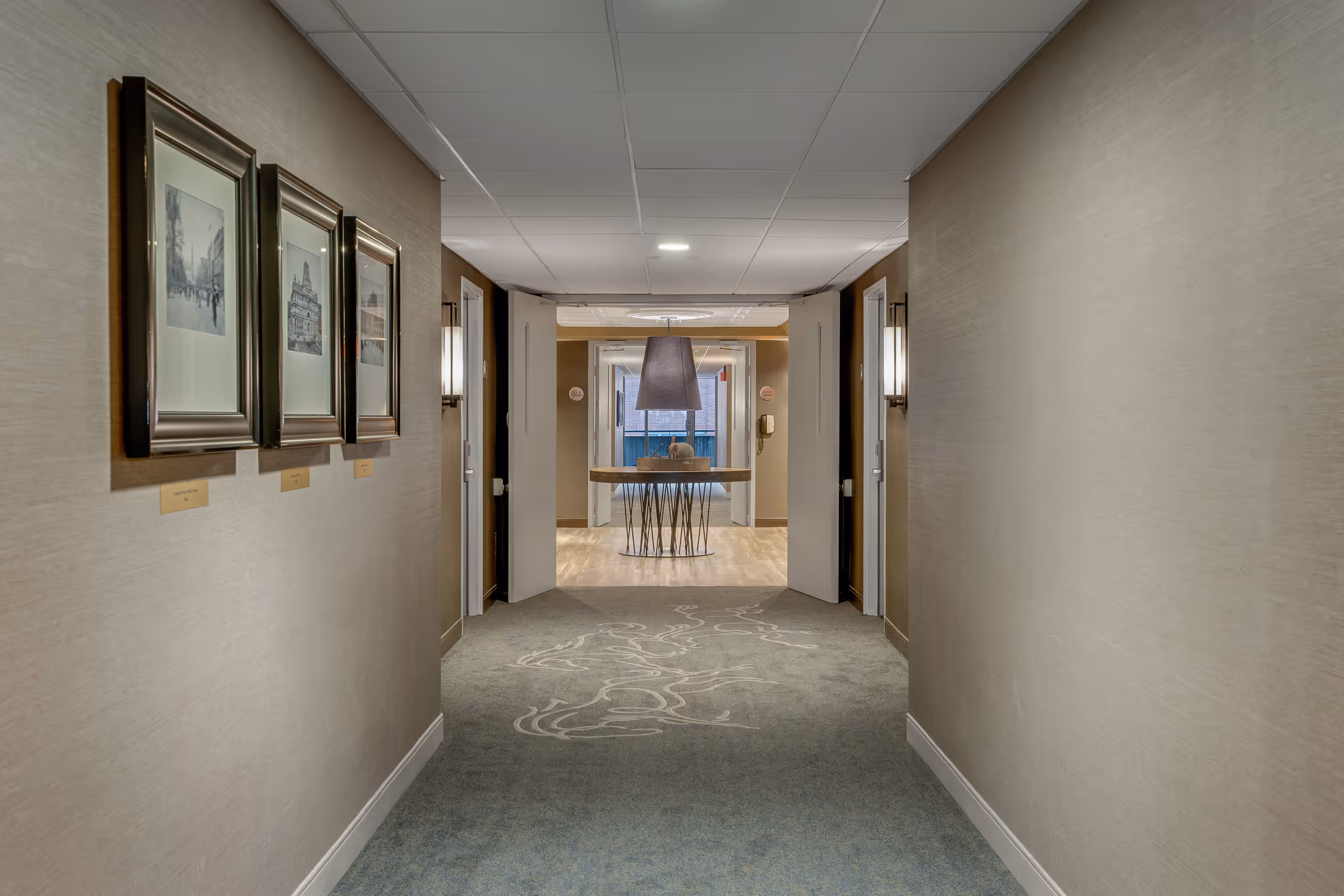 Hotel hallway with framed artwork and clean perspective