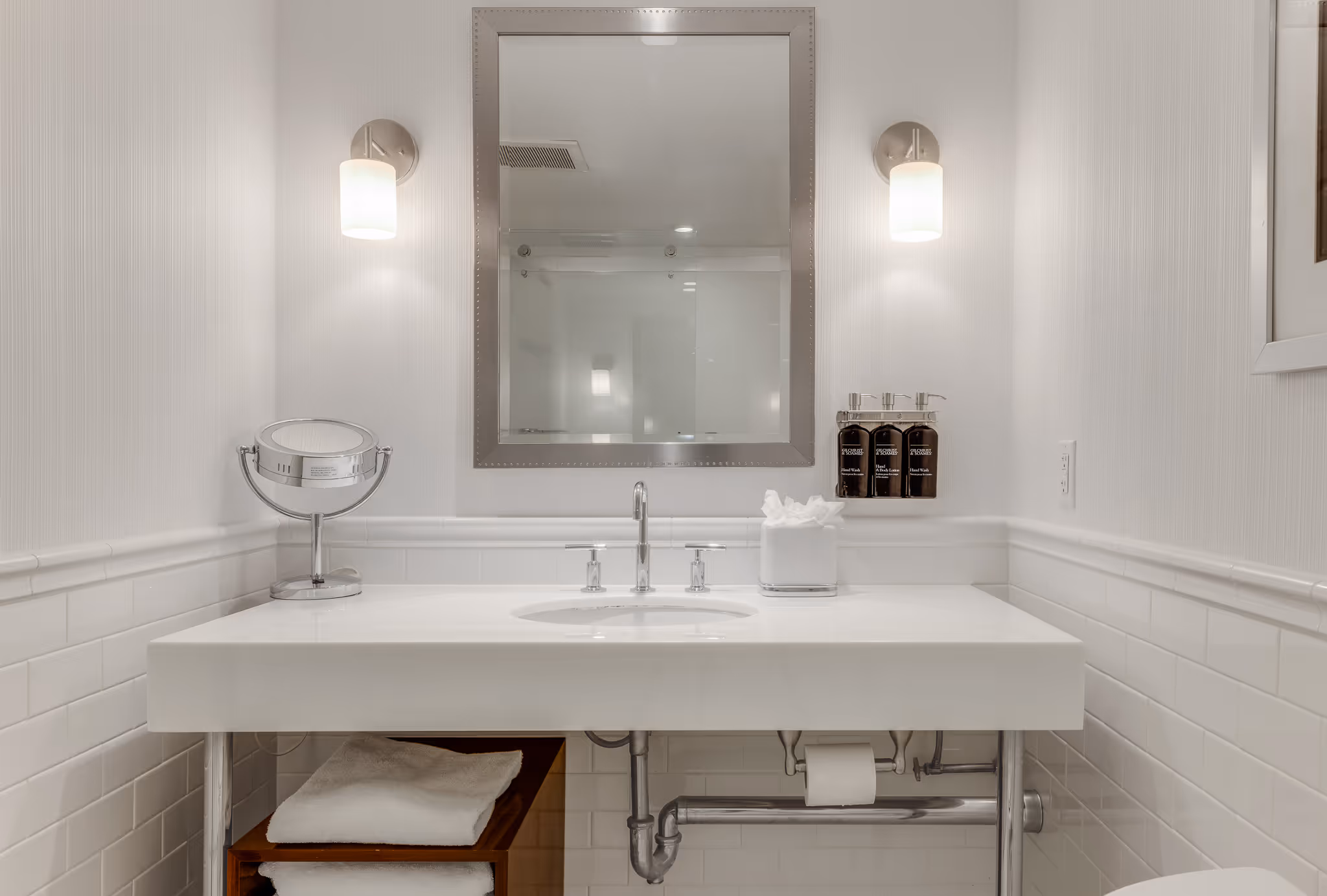 Bathroom vanity with mirror and clean lighting in hotel