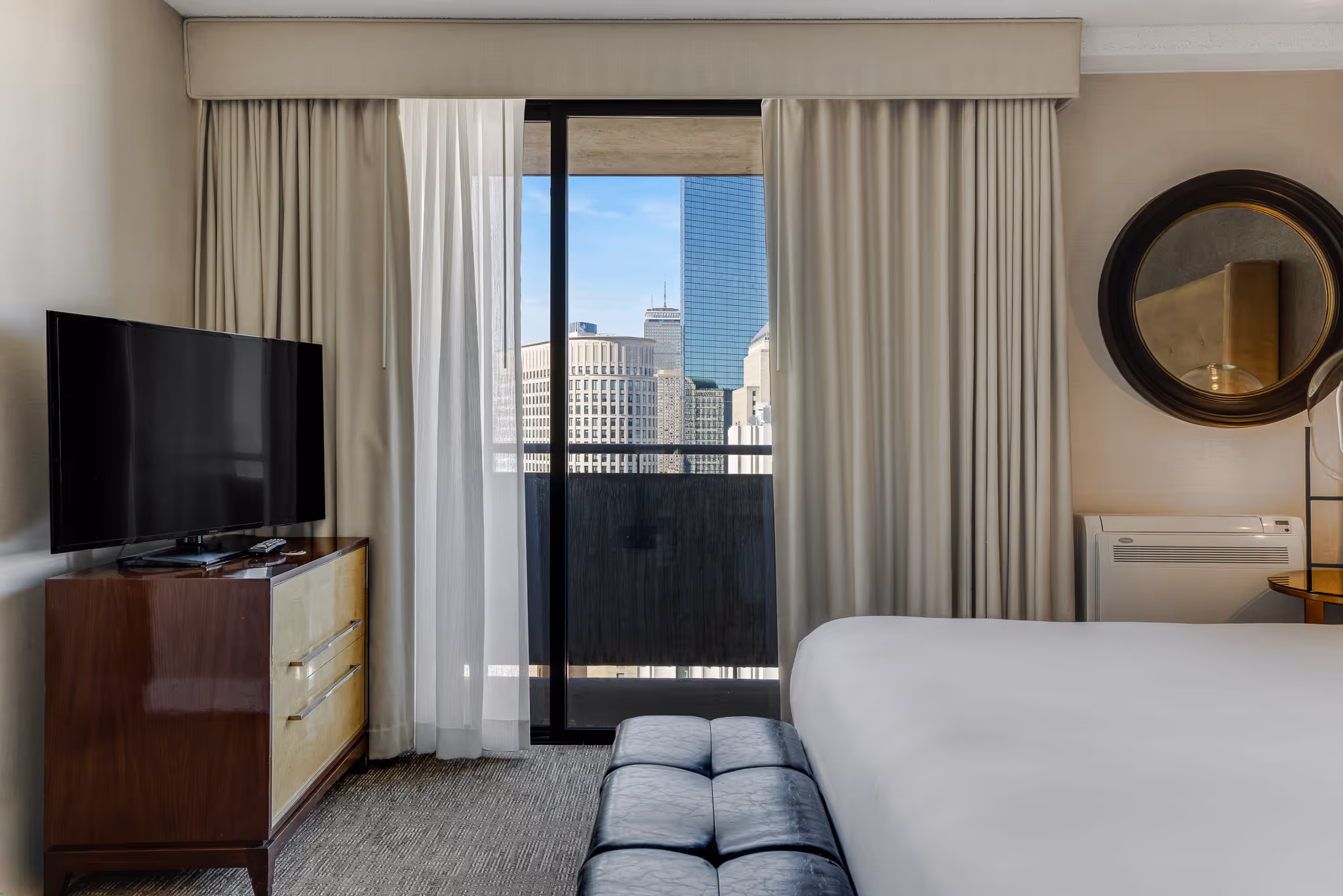 Hotel room with balcony view and natural light in Boston