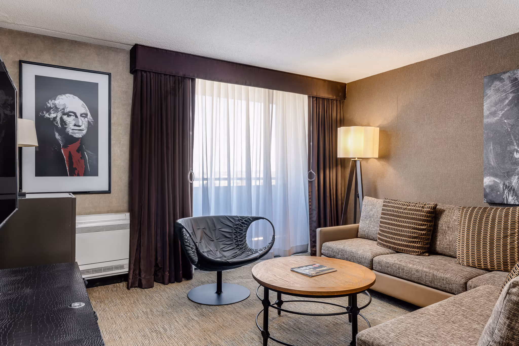 Hotel suite living area with sofa and coffee table in Boston