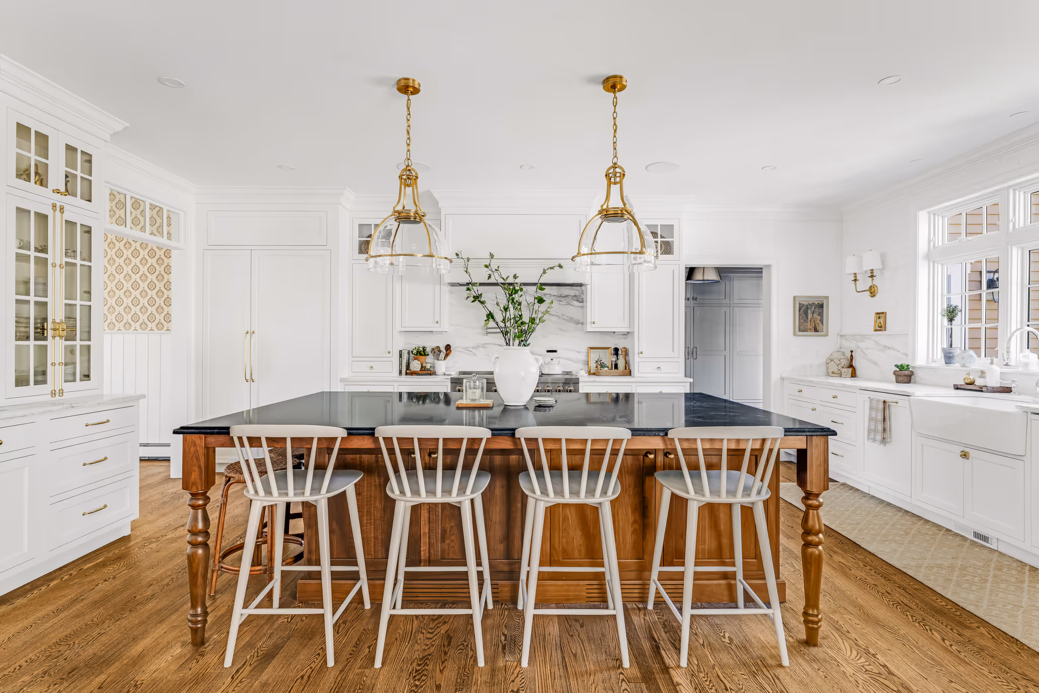 Open kitchen layout with large island and pendant lighting in Greater Bosto