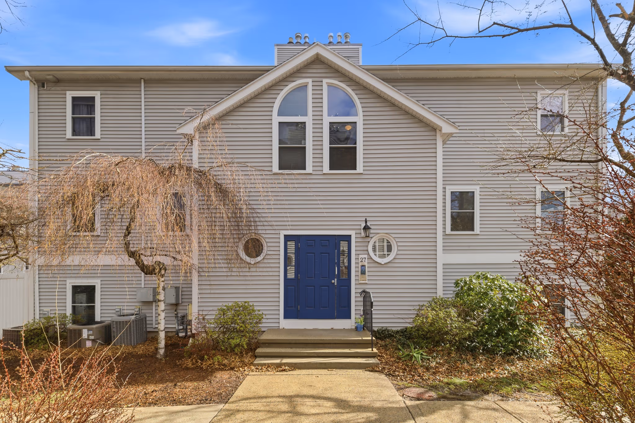 Front exterior of Boston condo building with entrance and landscaping