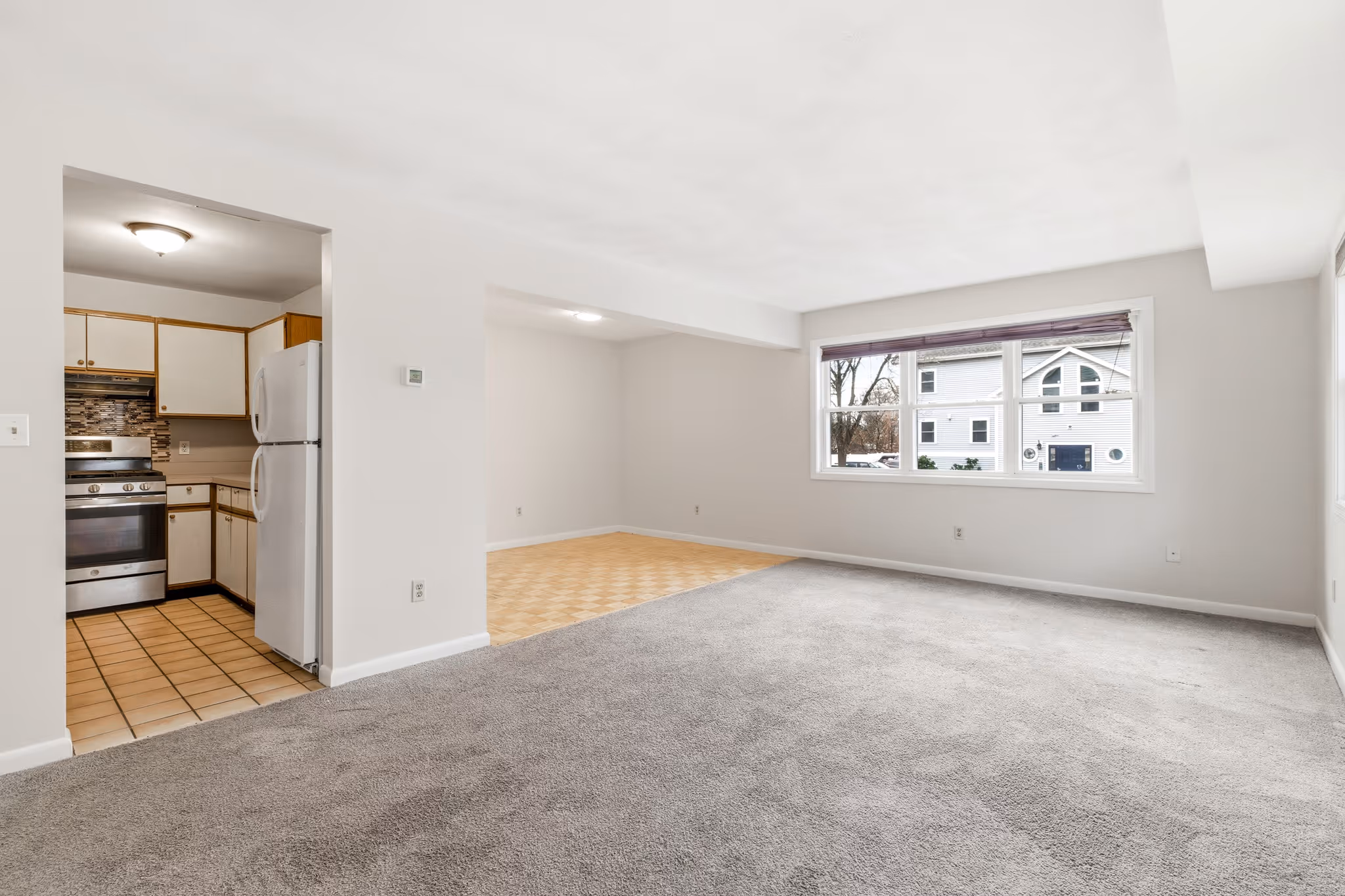 Spacious living area with carpet and natural light in Boston condo