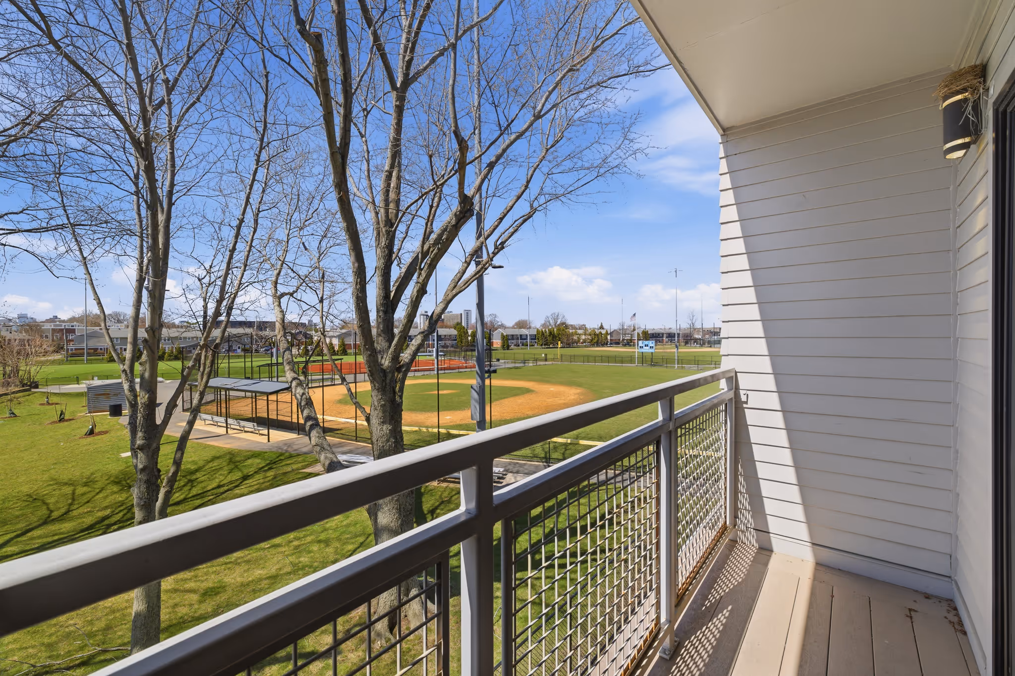 Private balcony with open park and baseball field views – Orient Heights condo, East Boston real estate photography