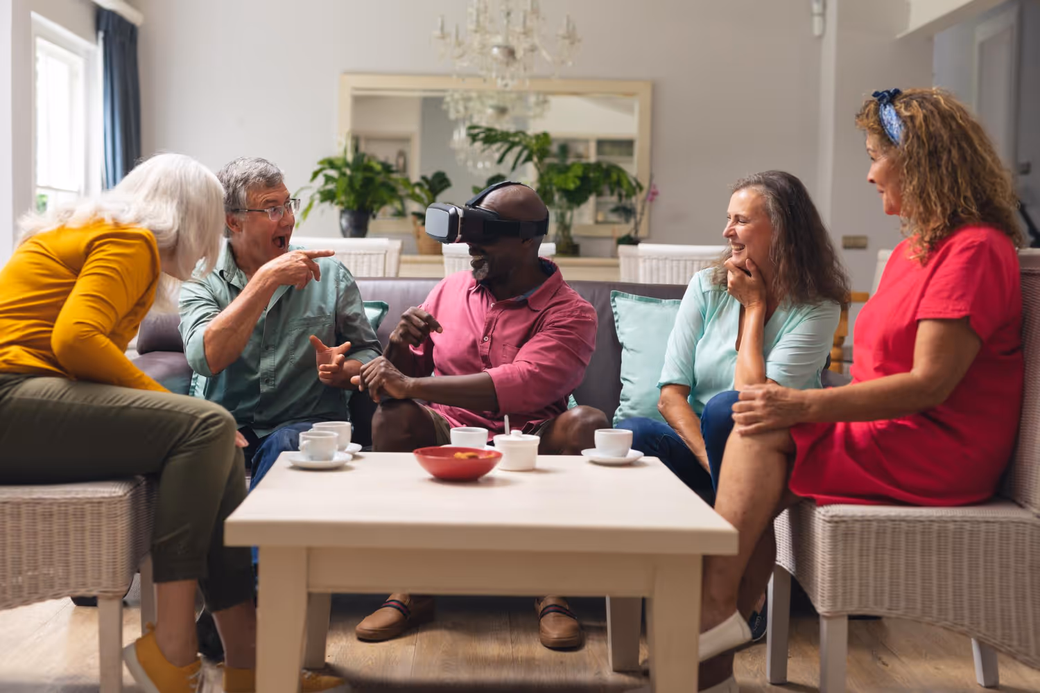 A group of people sitting together at a table, sipping coffee and conversing in a friendly, collaborative atmosphere.
